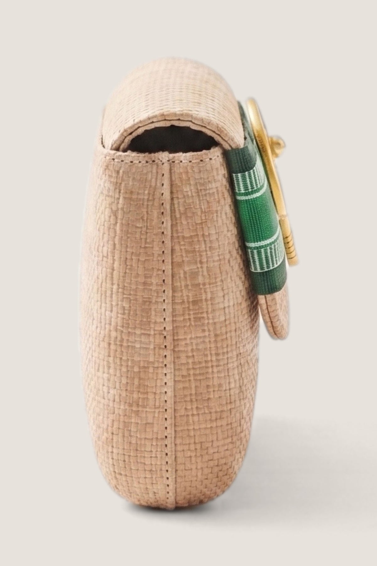 The Avery Straw Clutch seen from the side, showing its depth and the flap.