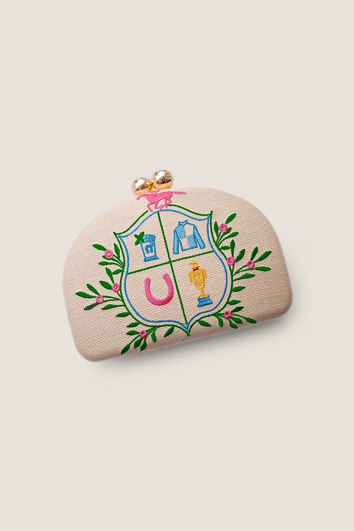 The Derby Embroidered Clutch seen at an angle, showing the curve and depth of the frame.