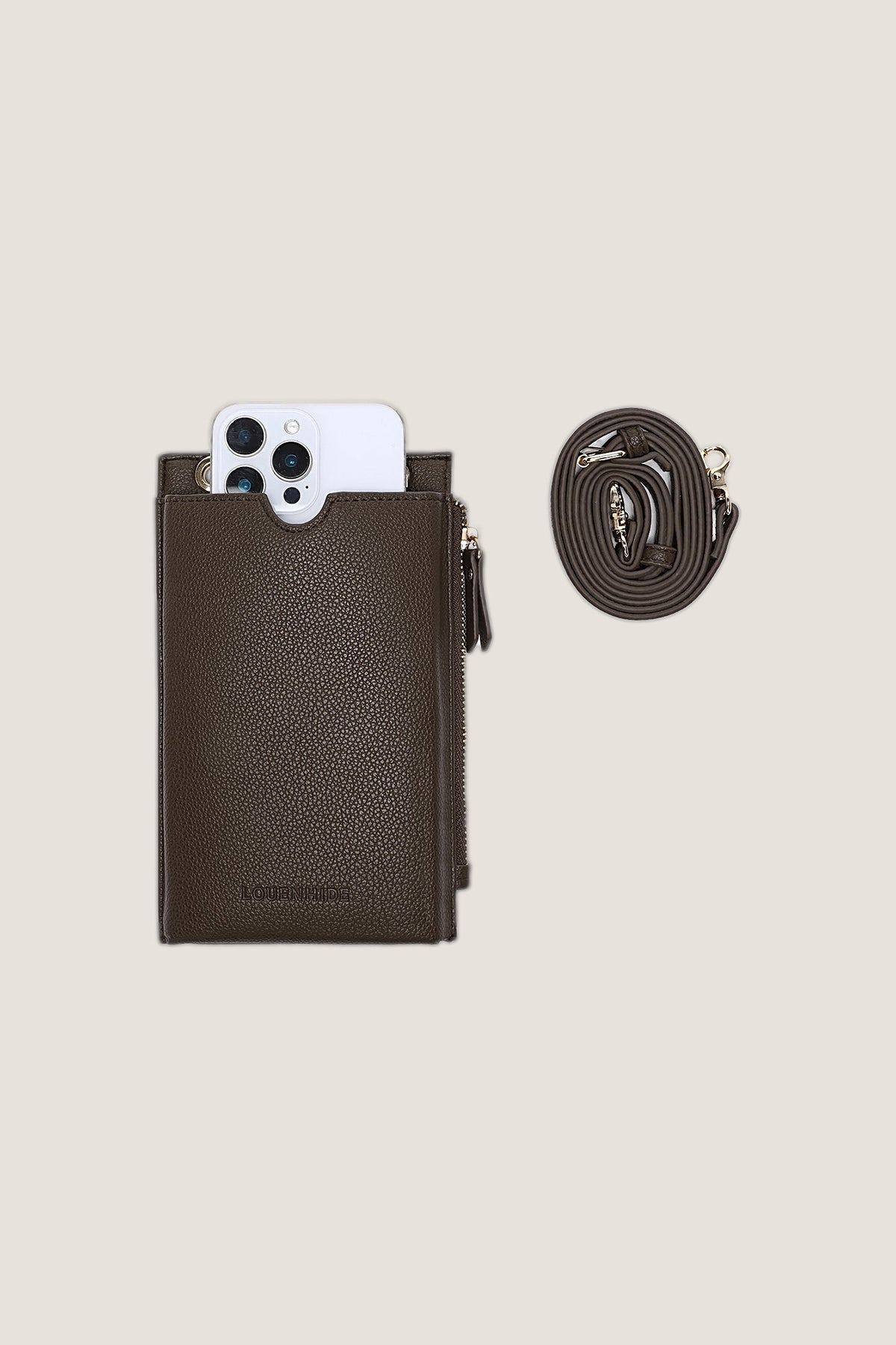 The Chocolate Suki Phone Crossbody Bag holding a large phone in its front slot, with the detachable strap coiled beside it.