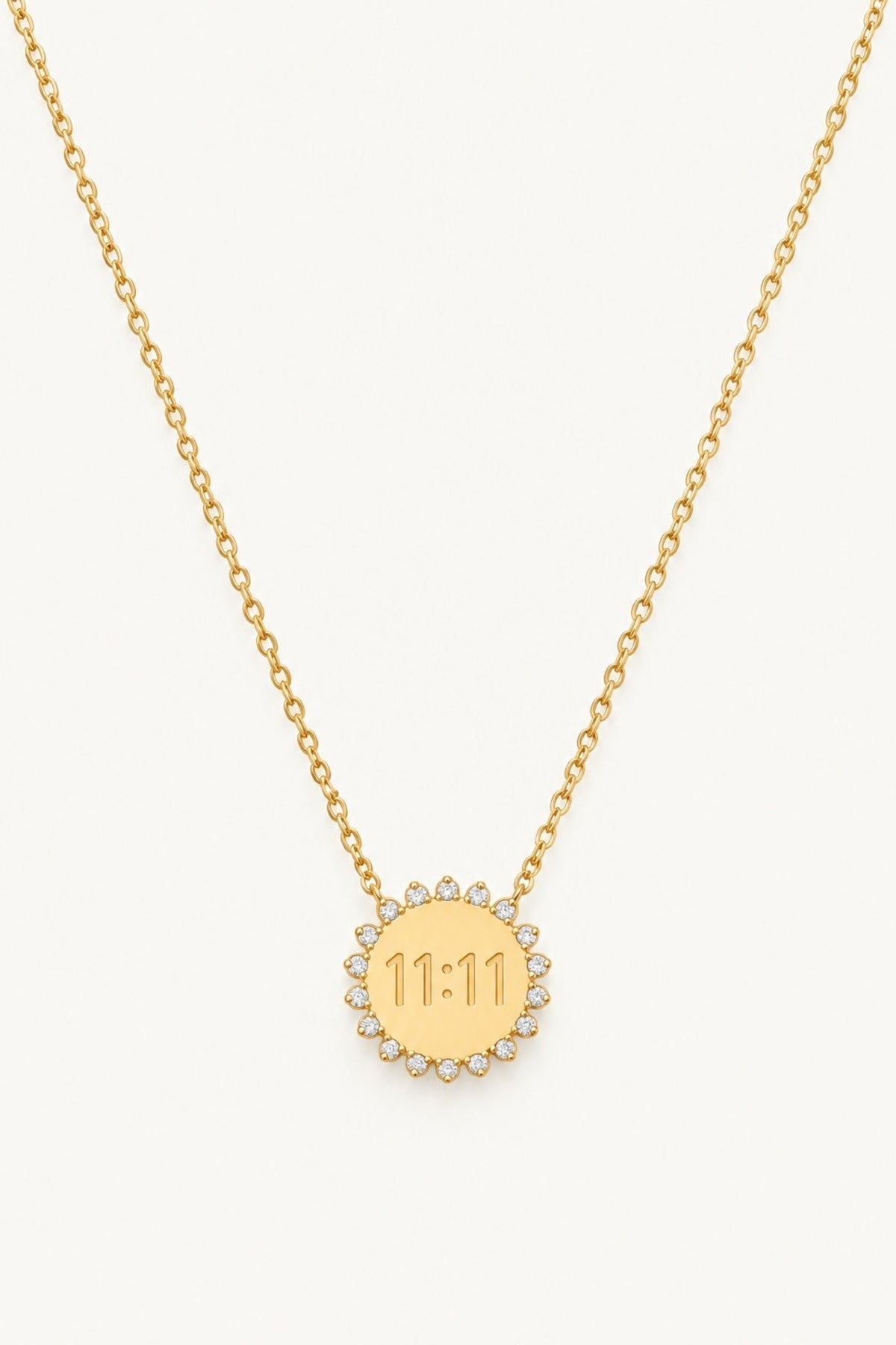 11:11 Sun Pendant Necklace – 14K Gold Plated on a cream background