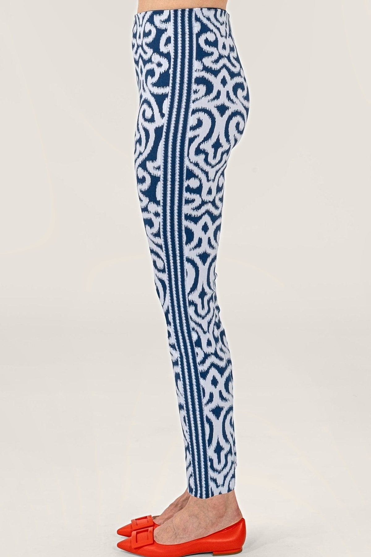 Side view of the navy arabesque print pull-on pants, showing the contrast side band.