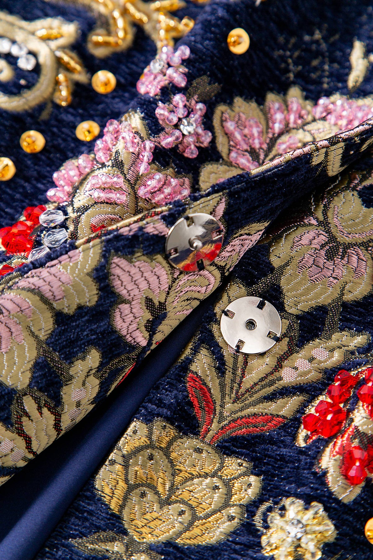 Close-up of the Artisan Studded Corduroy Long Coat front closure with mother-of-pearl snaps and beadwork