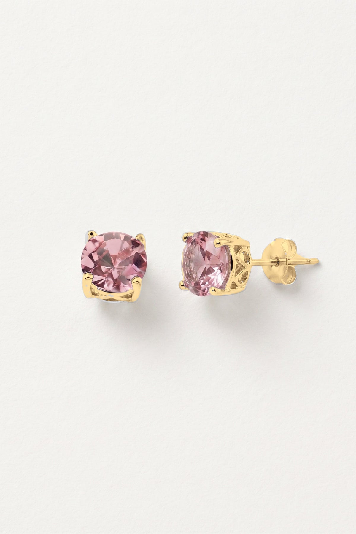 Baby Pink Sparkle Stud Earrings: a pair of round pink crystal studs in a gold-tone prong setting, one turned to show the post.