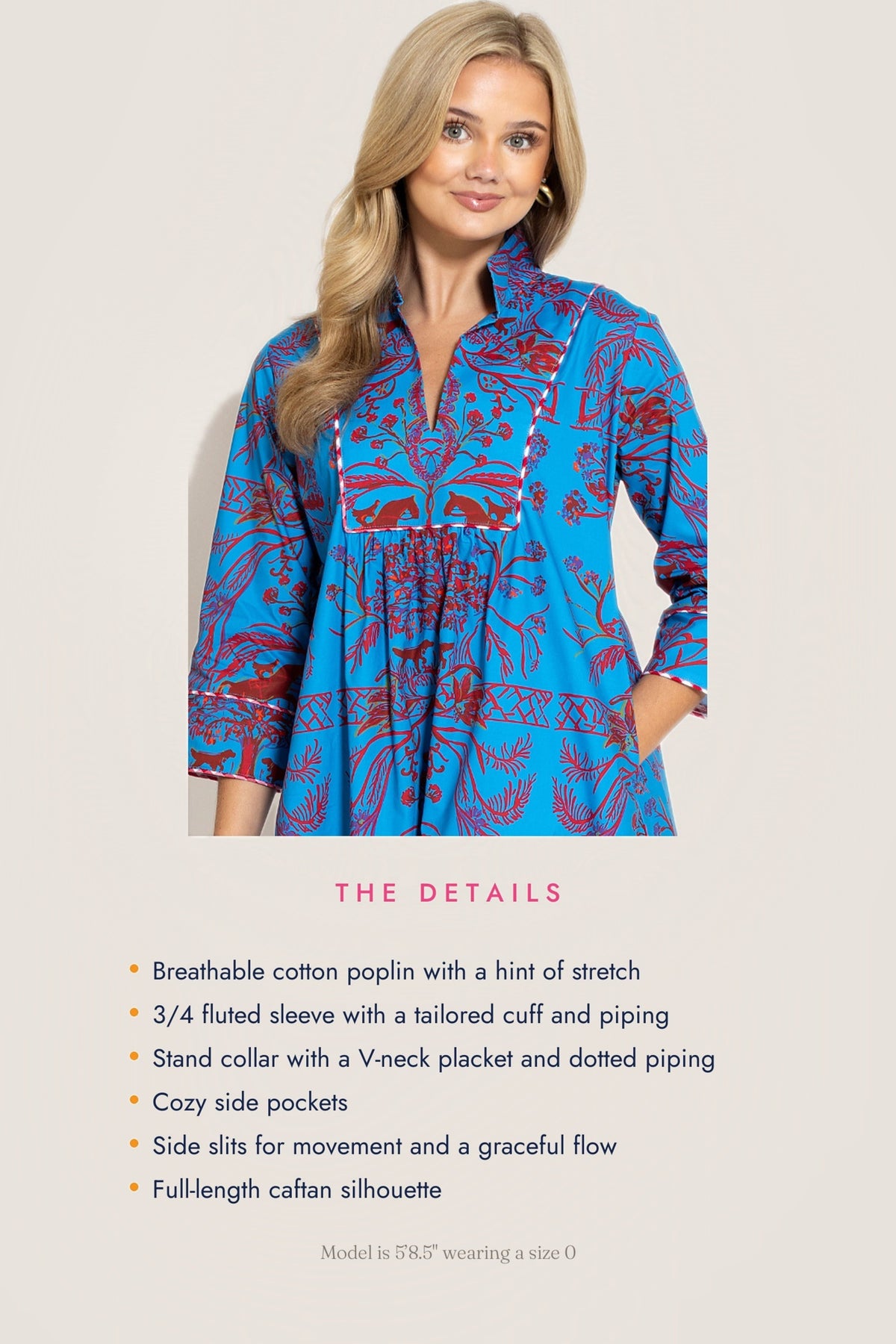 A woman models a bright blue cotton poplin tunic dress with a red and white floral pattern, shown against a light beige background with product details listed below.