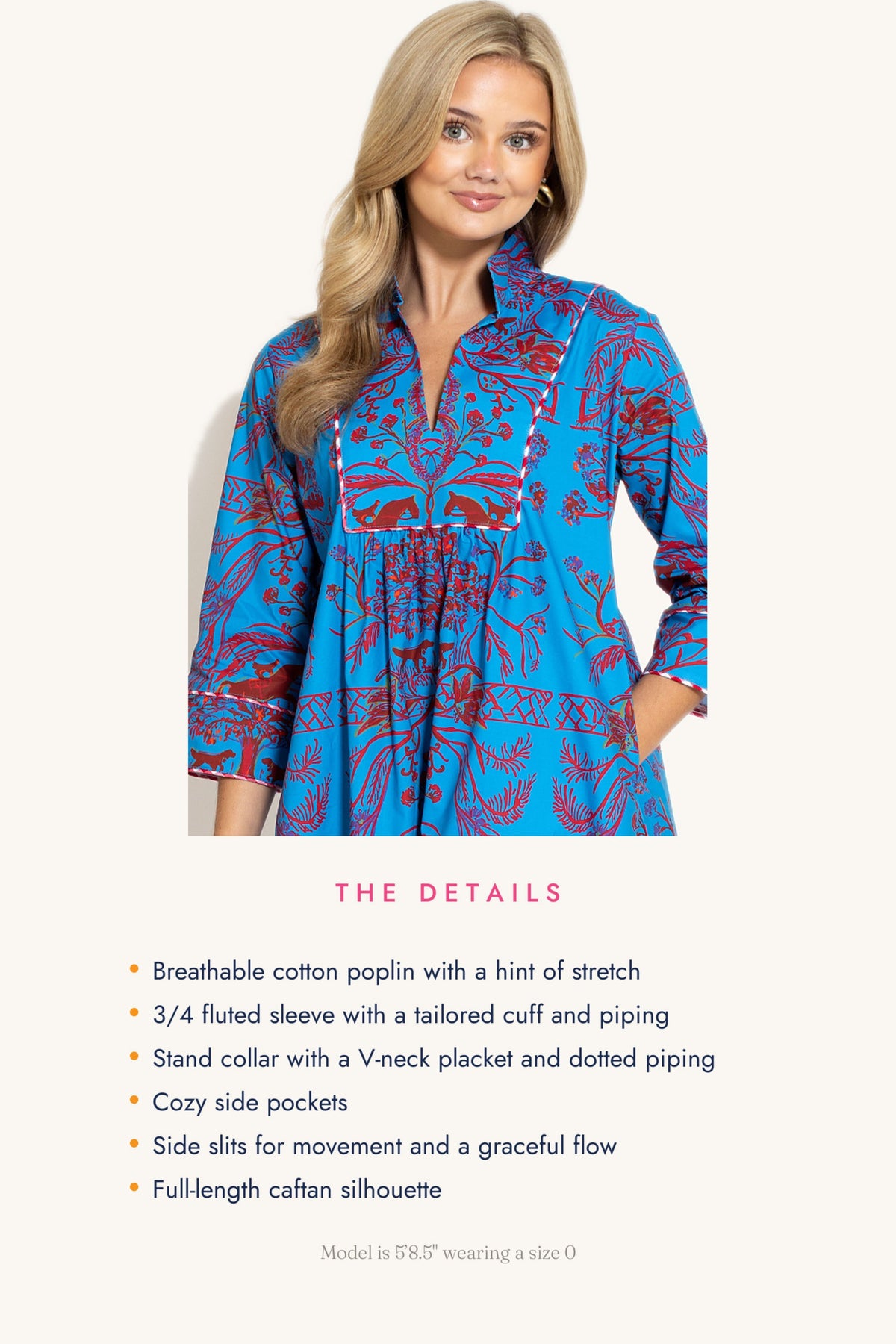 A woman models a bright blue cotton poplin tunic dress with a red and white floral pattern, shown against a light beige background with product details listed below.