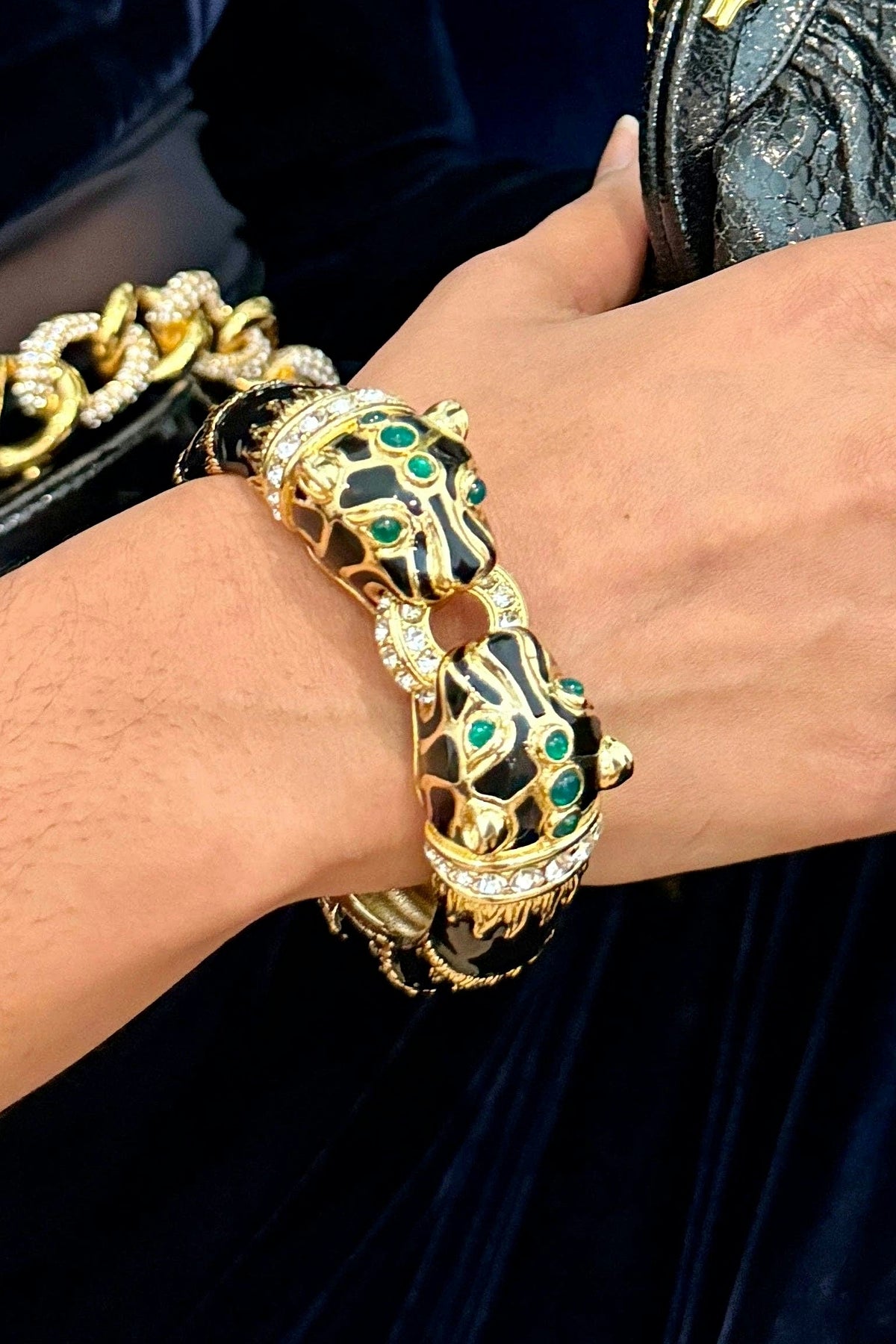 Black Enamel Double Panther Bracelet worn on the wrist, showing its size against the hand.