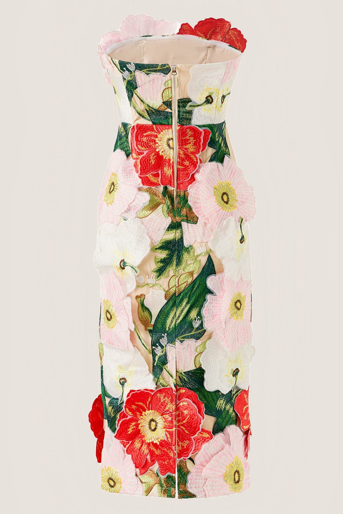 A strapless mini dress with a front zipper, featuring a 3D floral applique design in red, pink, white, and green on a light beige background.