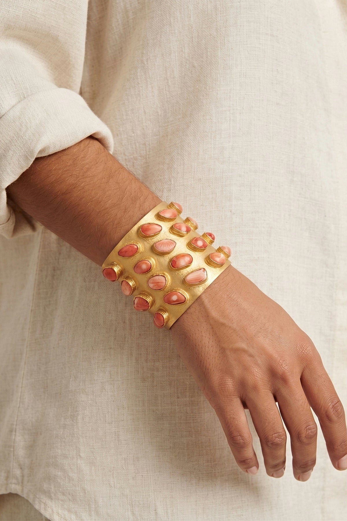 Coral Legacy Cuff worn on the wrist with a white linen shirt, showing how wide the cuff sits.