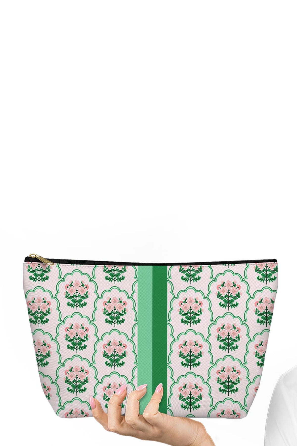 The Cottage Grove mahjong tile bag in pink and green floral print with a green centre stripe, held in one hand.