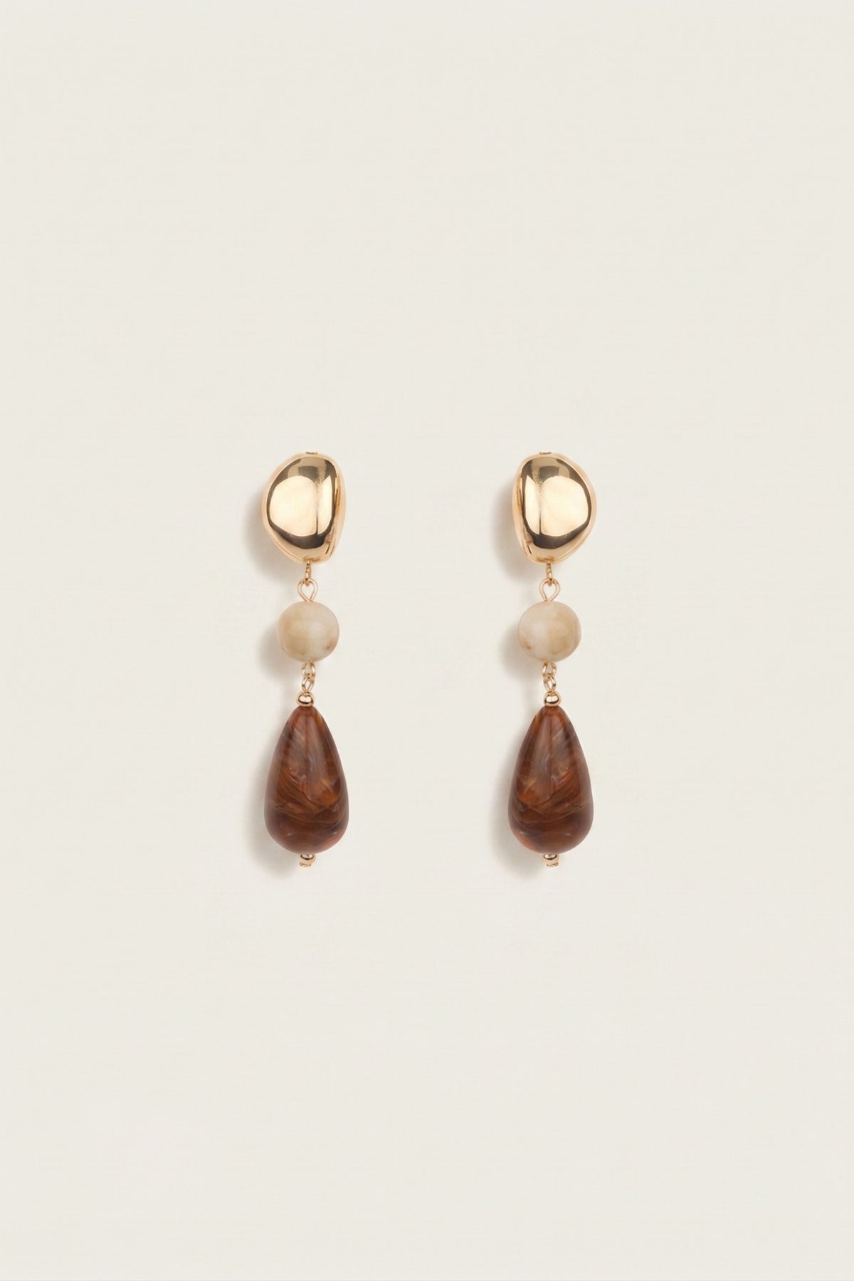A pair of drop earrings with gold bean shape and then different colored gemstones 