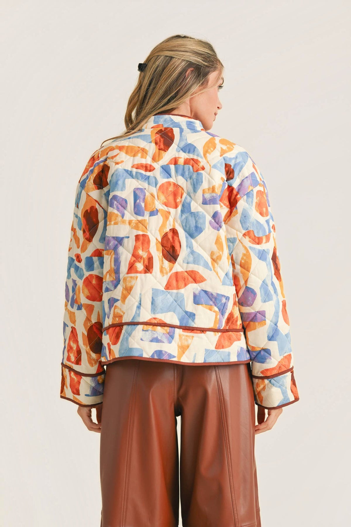 Back view of the Exclusive Print Quilted Jacket showing the quilting, drop shoulders and contrast binding at the hem and cuffs