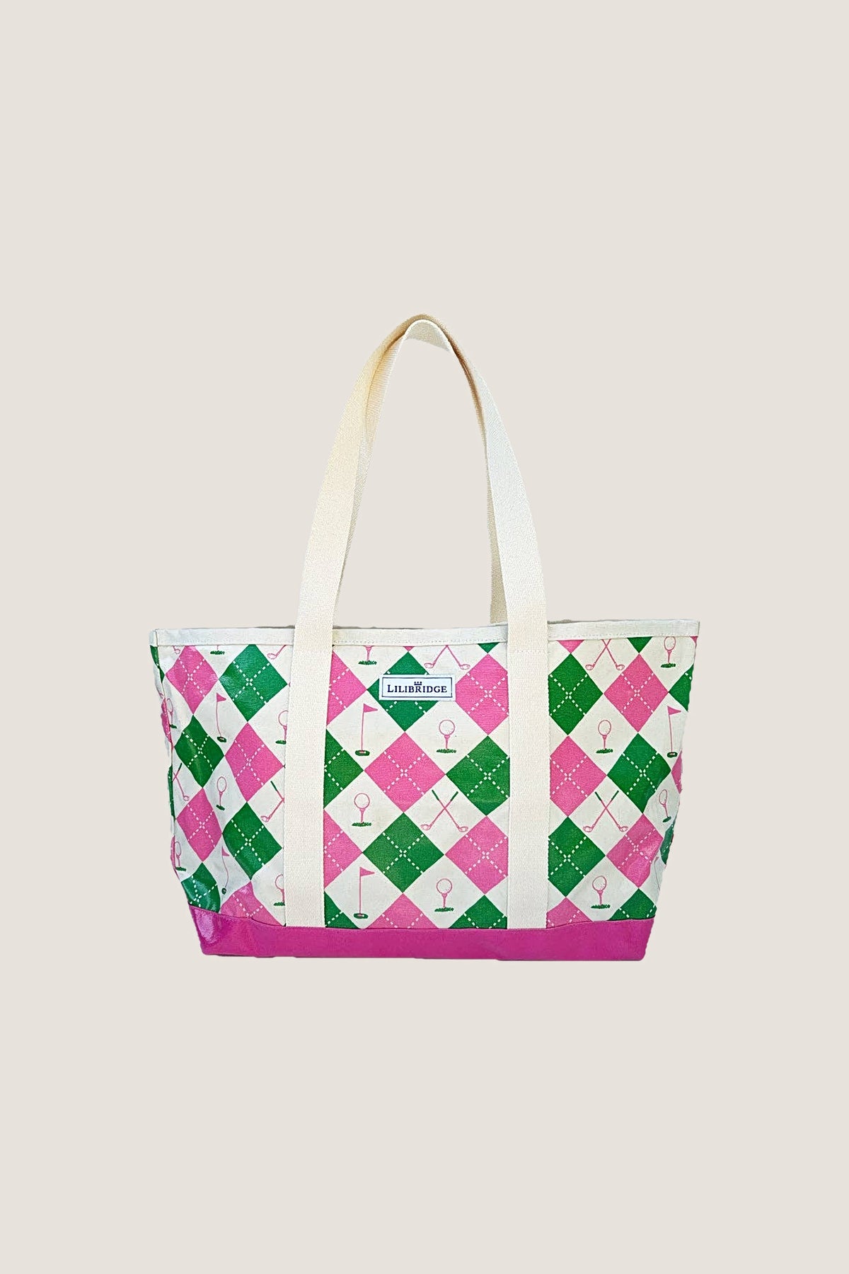 The Forevermore Golf Tote in a pink and green argyle print with golf flags and tees, natural webbing handles and a glossy pink base, front view.