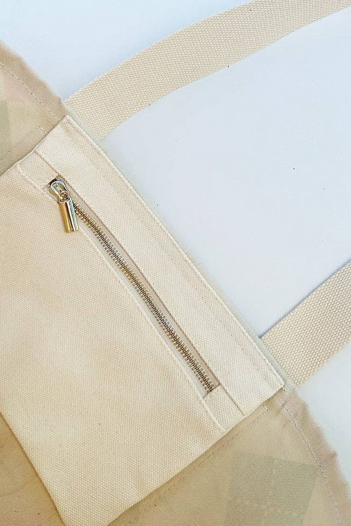 Inside the Forevermore Golf Tote, showing the natural canvas lining and the zip pocket.