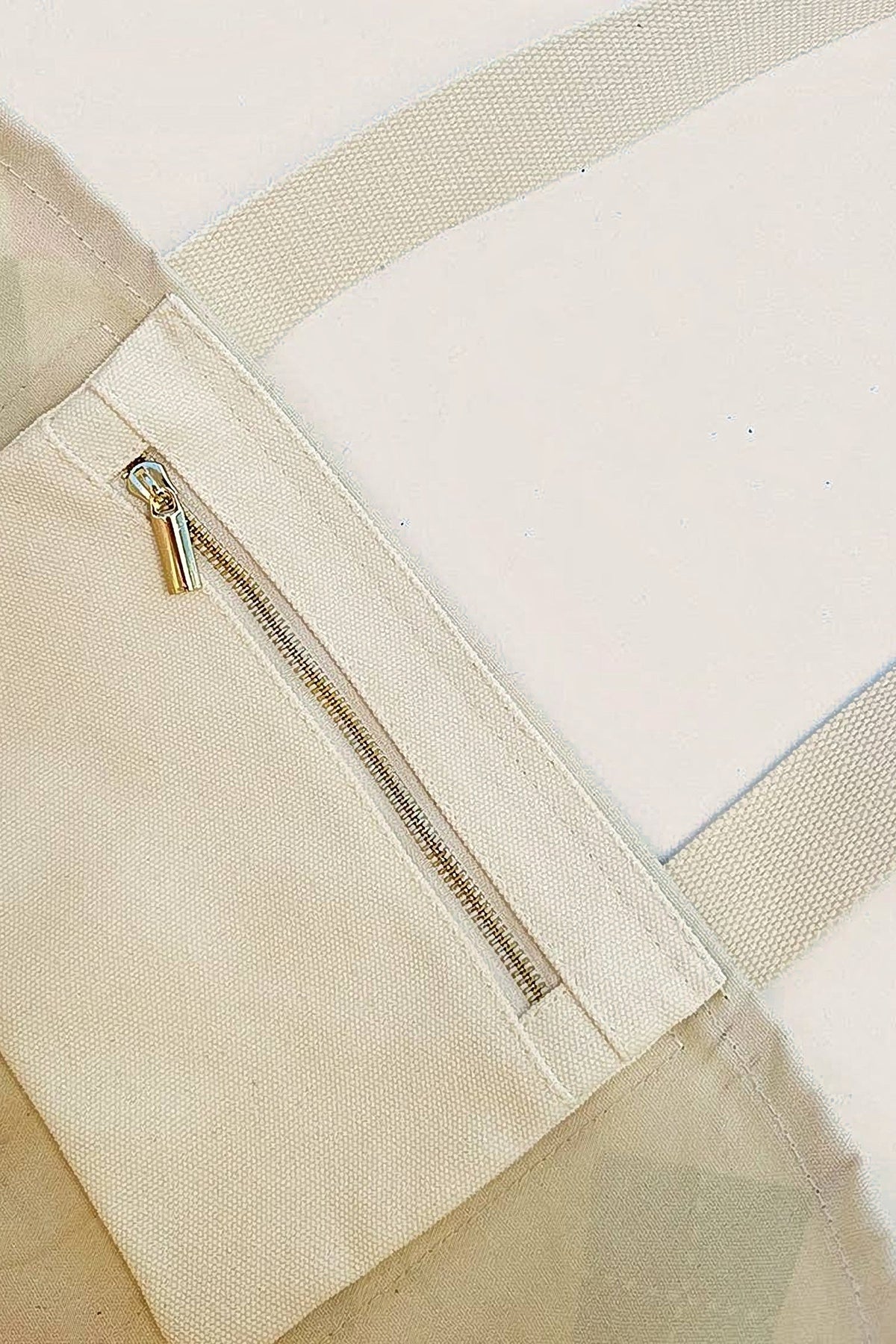Inside the Forevermore Golf Tote, showing the natural canvas lining and the zip pocket.