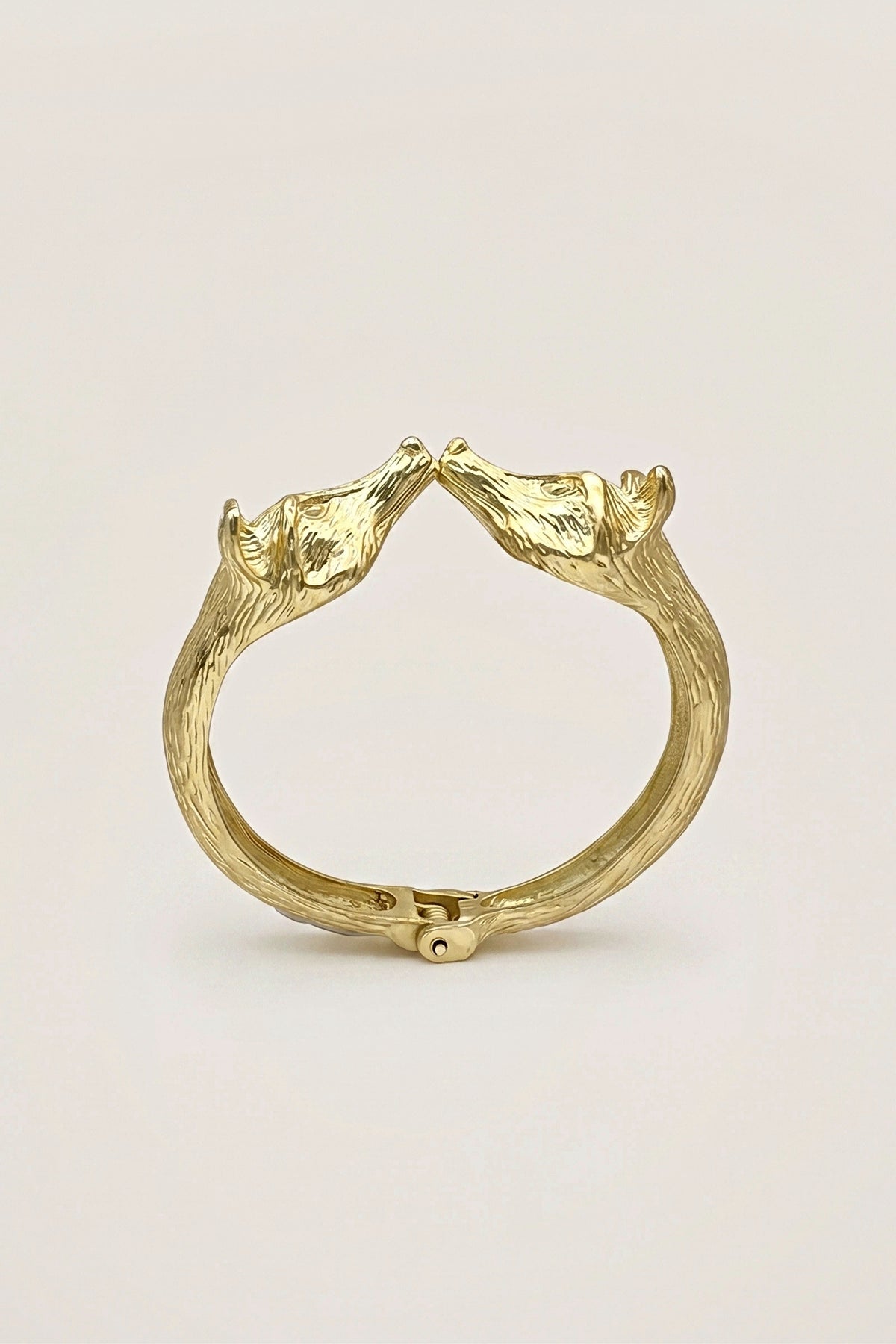 Golden Fox Hinged Bracelet standing upright, with the fox heads at the top and the hinge at the bottom.