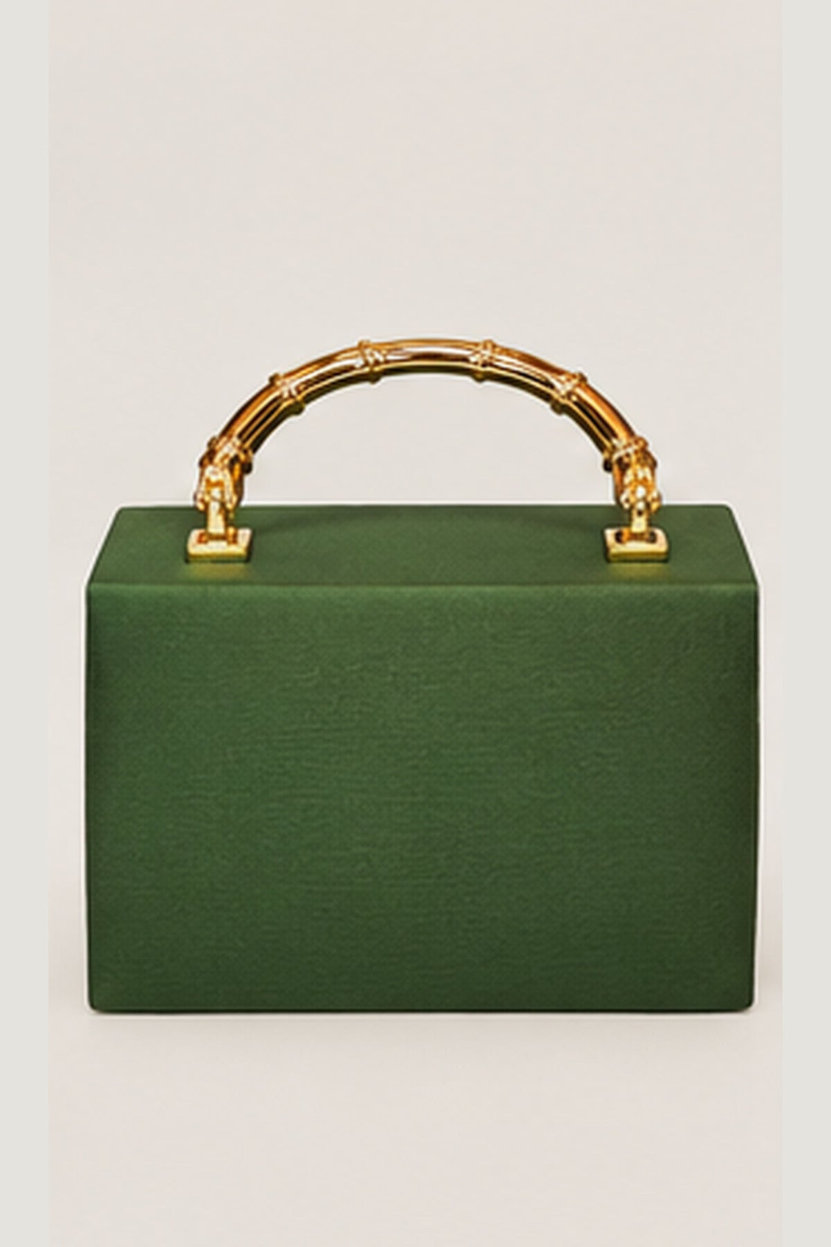 A structured green clutch bag with a bamboo-style gold handle, shown against a plain light gray background.