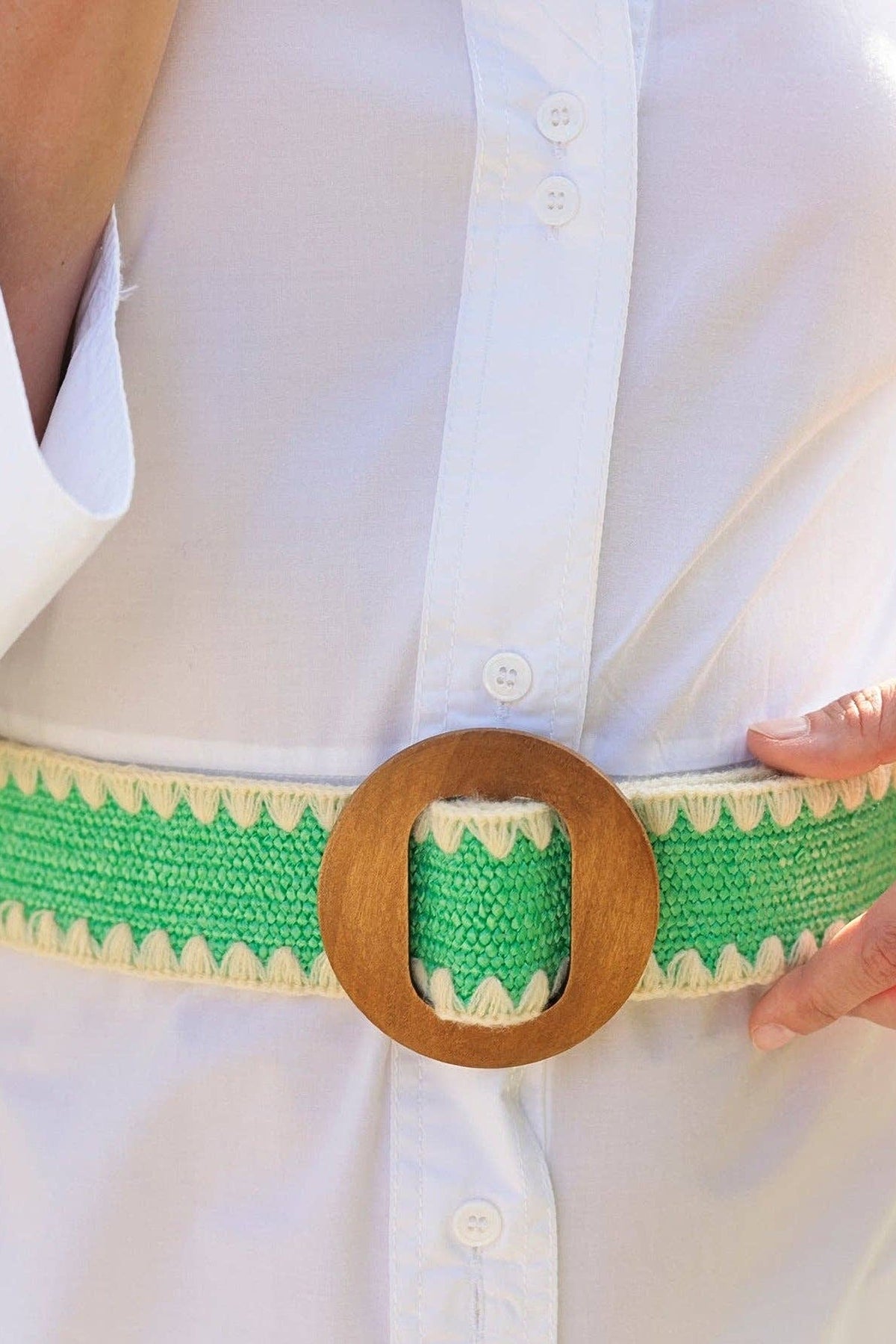 A close view of the Kayla Green Belt worn at the waist over a white shirt dress, showing the round wood buckle.