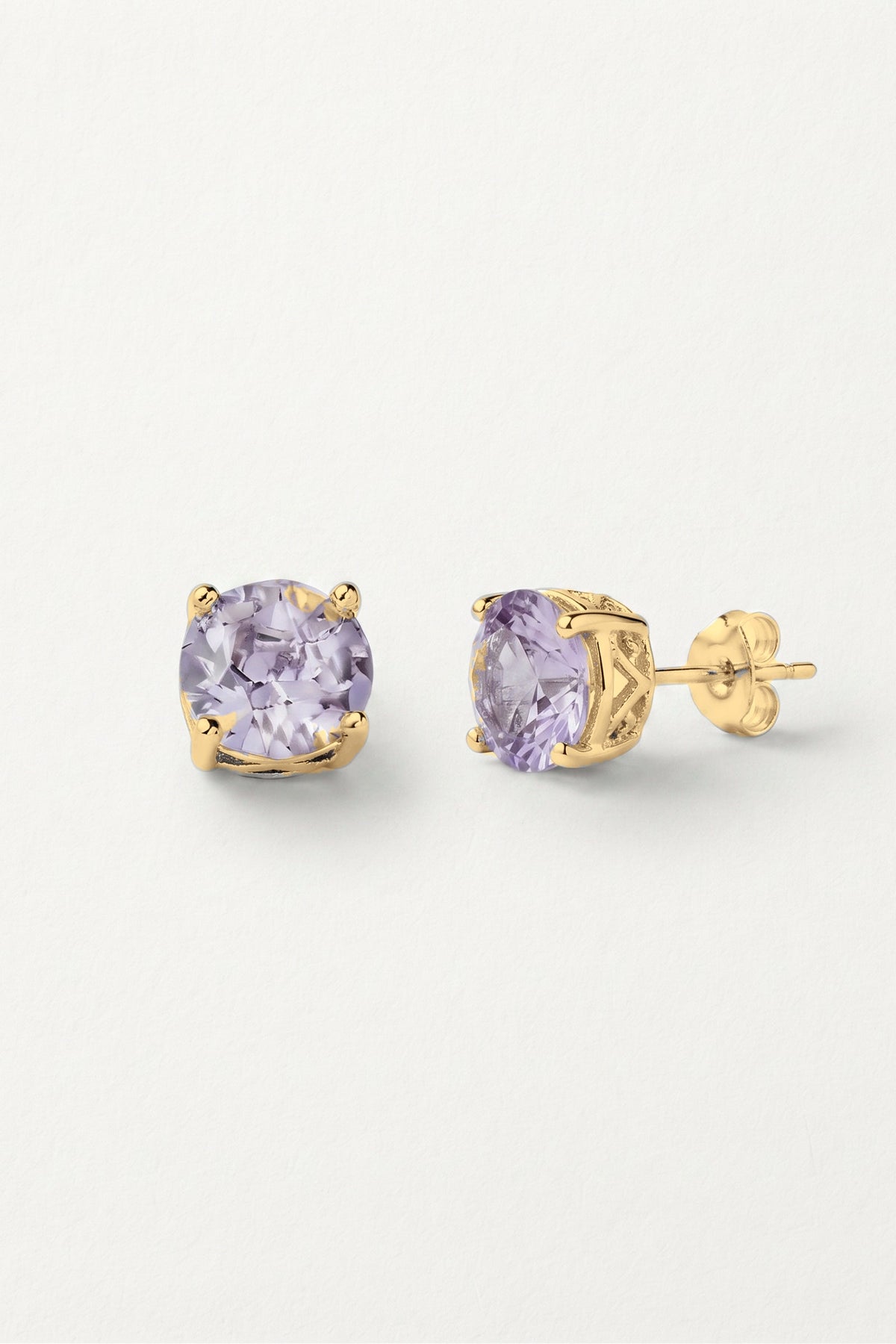 Lavender Sparkle Stud Earrings: a pair of round lavender crystal studs in a gold-tone prong setting, one turned to show the post.