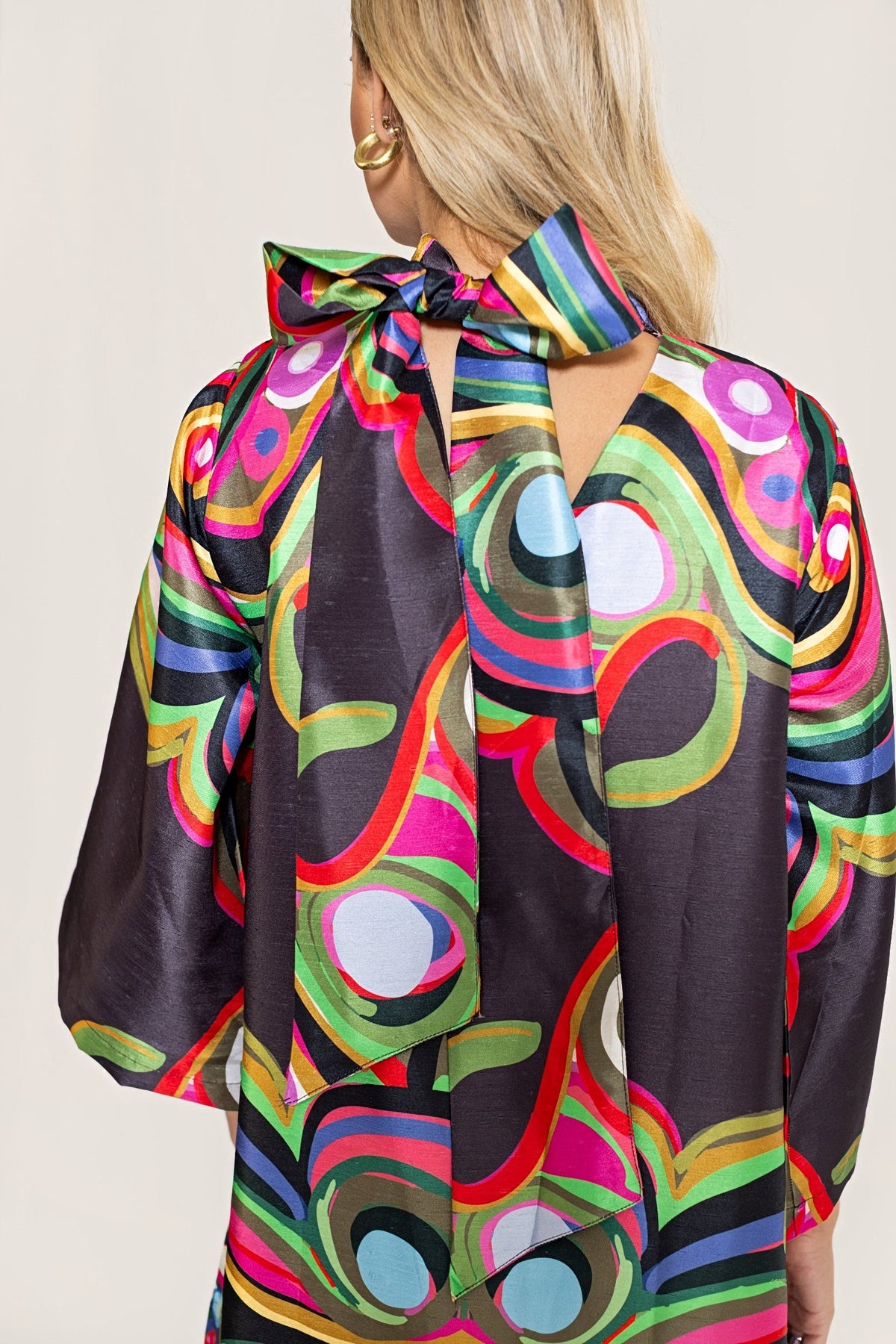 A close view of the back of the Merriweather Darling Dress with the collar tied in a bow.