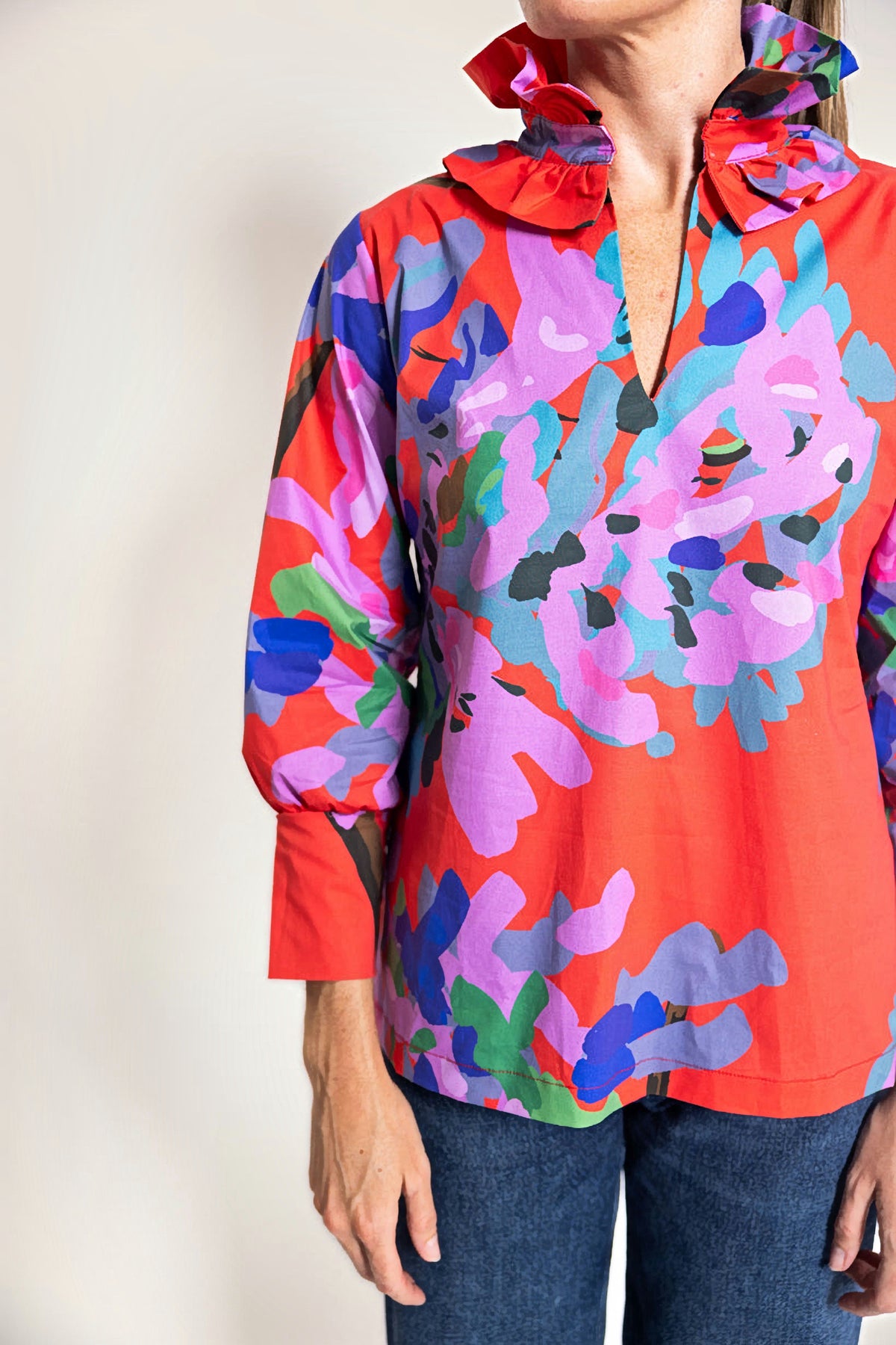 Close-up of the Miss Scarlet Harper Estate Top showing the pleated ruffle stand collar, split neckline and the red, pink and blue floral print