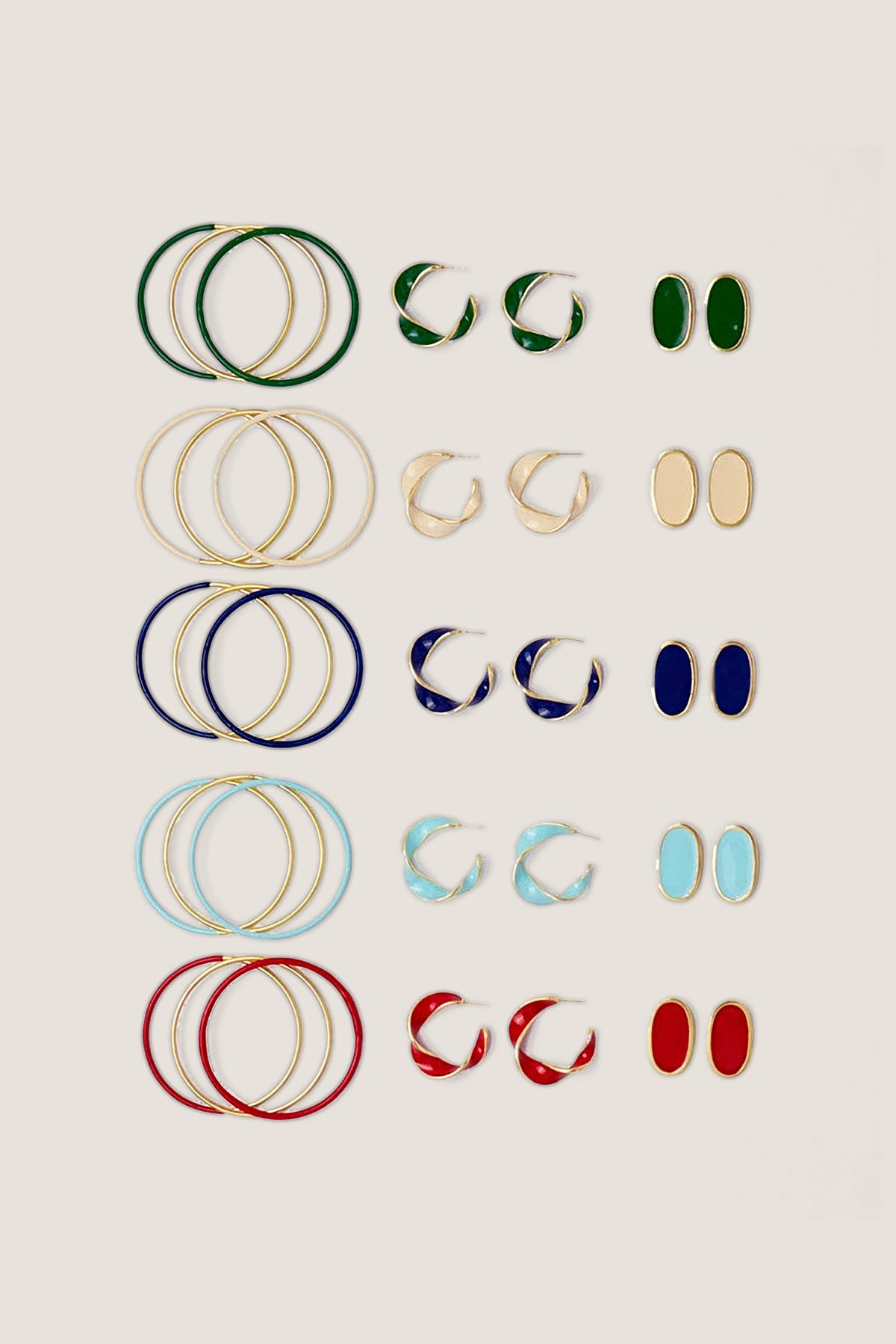 The Alexis oval enamel post earrings in all five colours, including navy, laid out with matching enamel hoops.