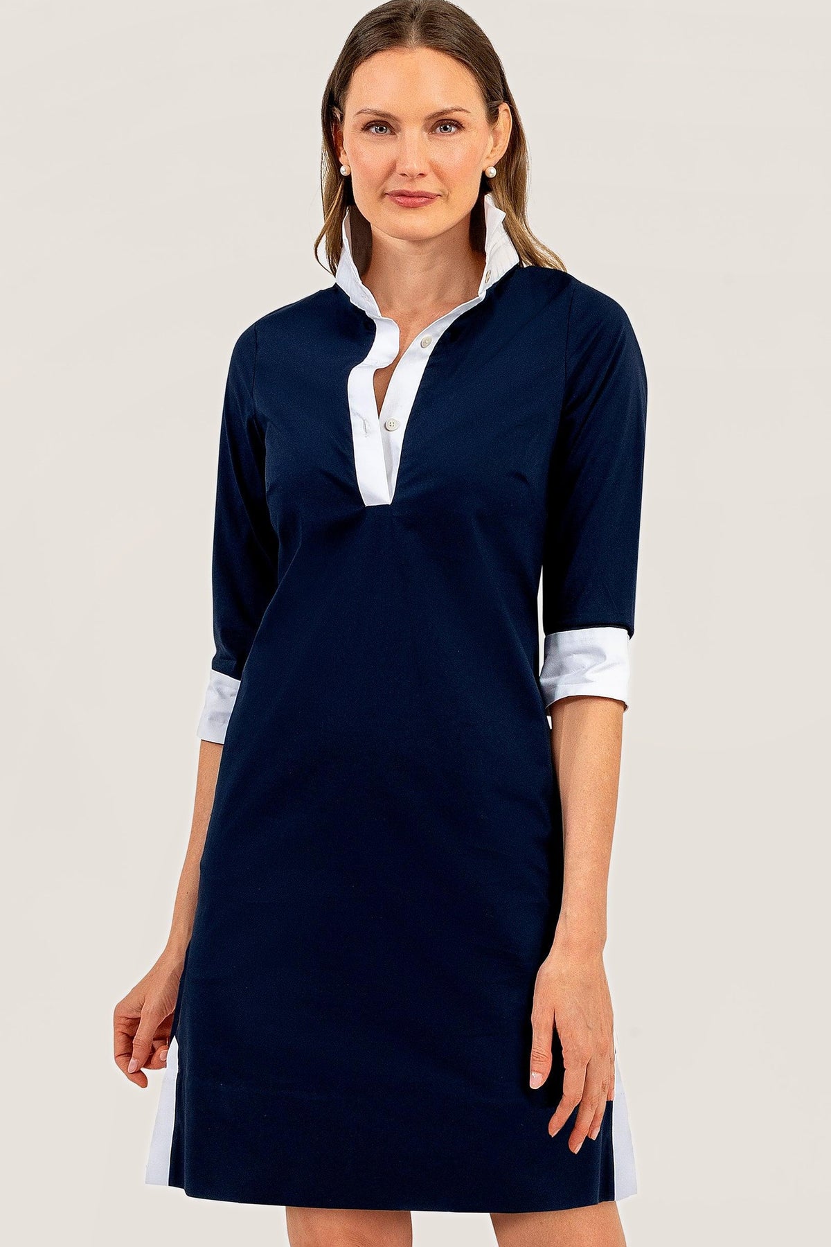 Front view of the navy cotton tunic dress with a white stand collar, placket and cuffs.
