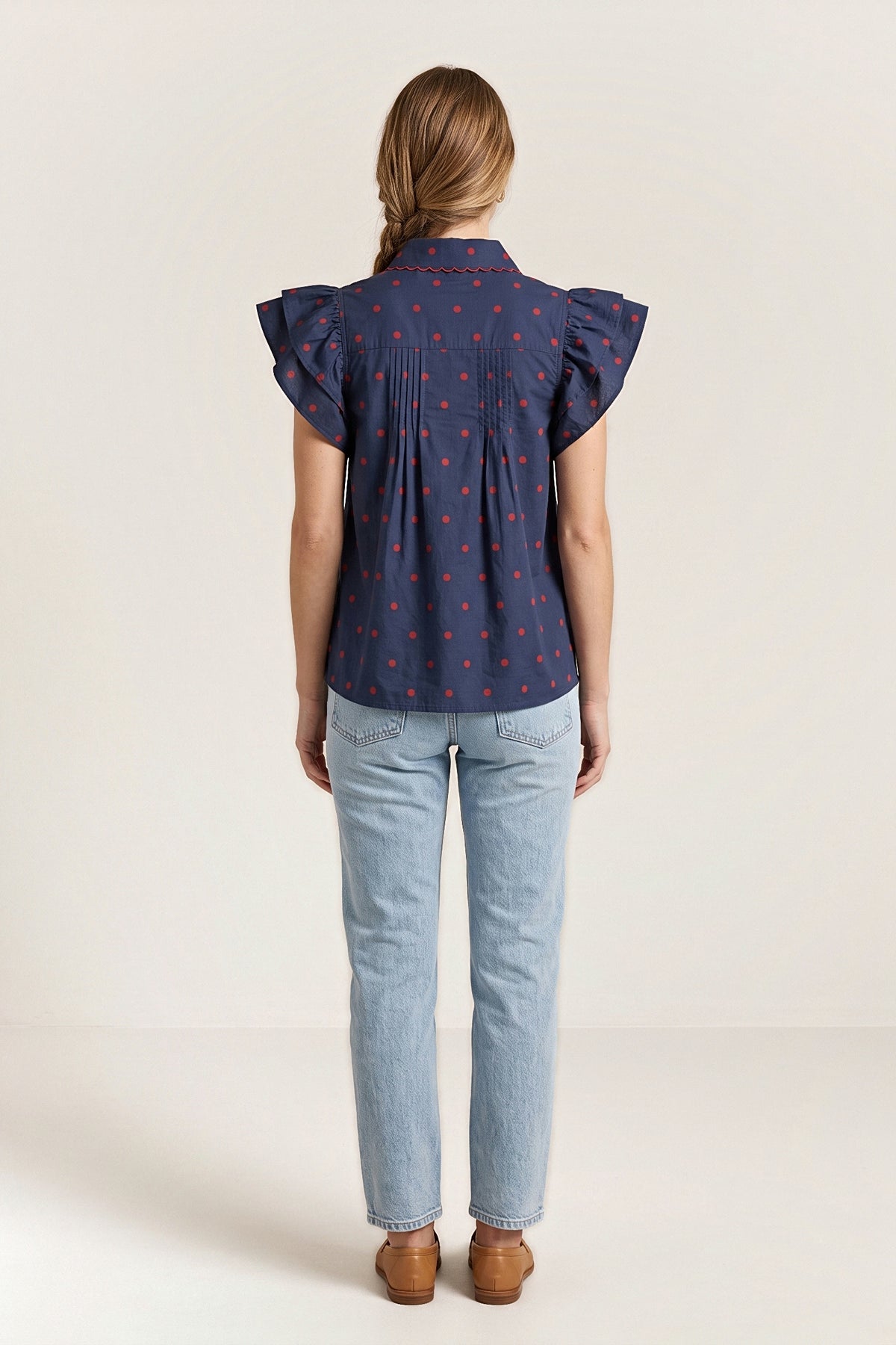 Back view of the navy sailmaker blouse with a shoulder yoke and pintucks.
