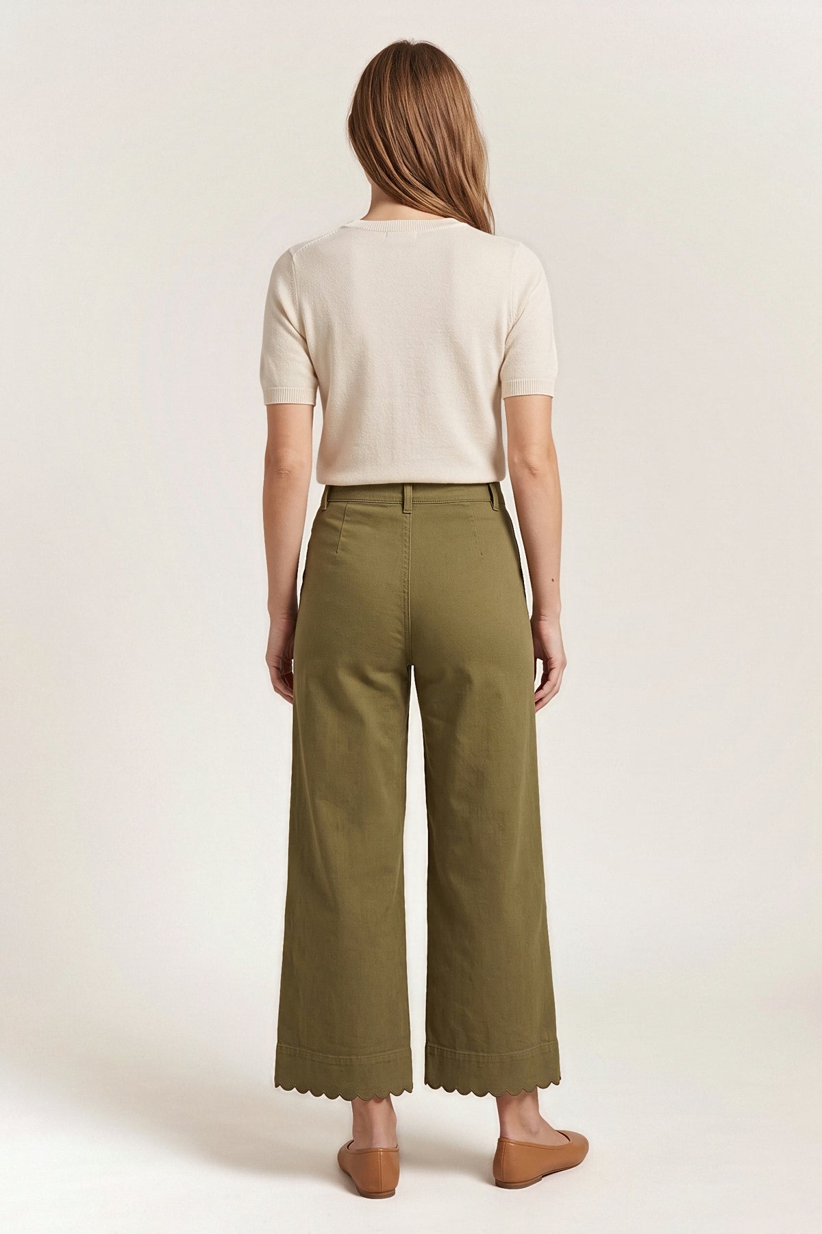 Back view of the olive Maribel wide-leg pants showing the belt-loop waistband and the scalloped hem.