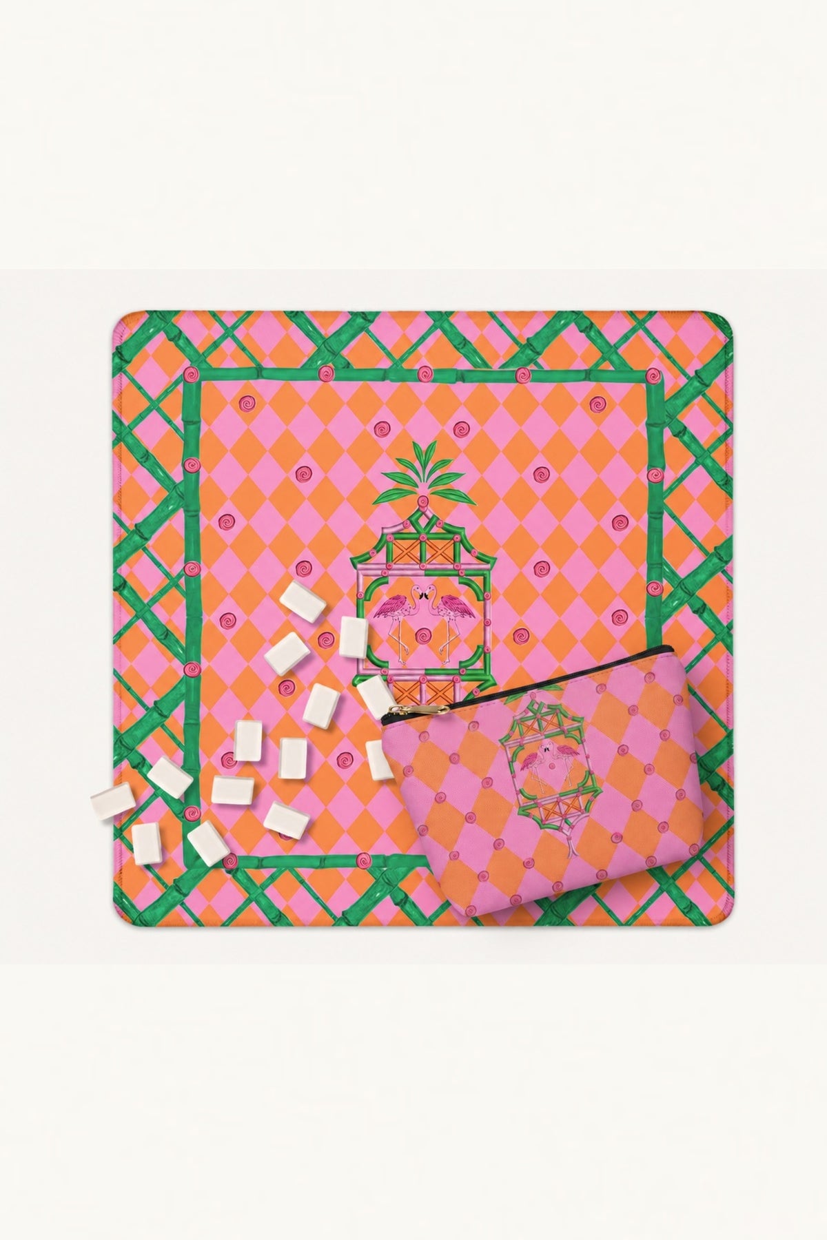 The Palm Beach Pagoda mahjong tile bag lying on the matching mahjong mat with tiles scattered beside it.