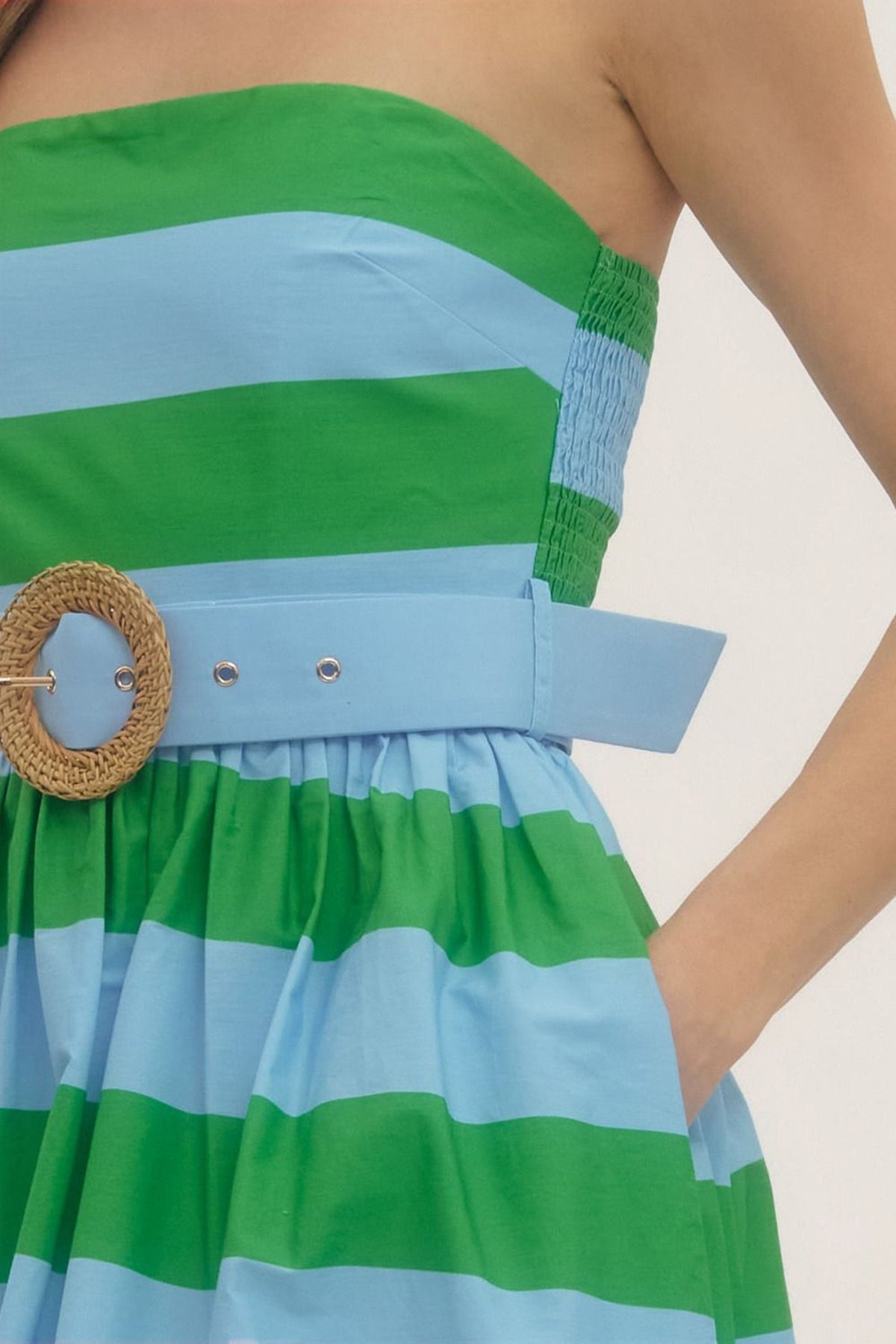 Close-up of the woven buckle belt and wide green and blue stripes.