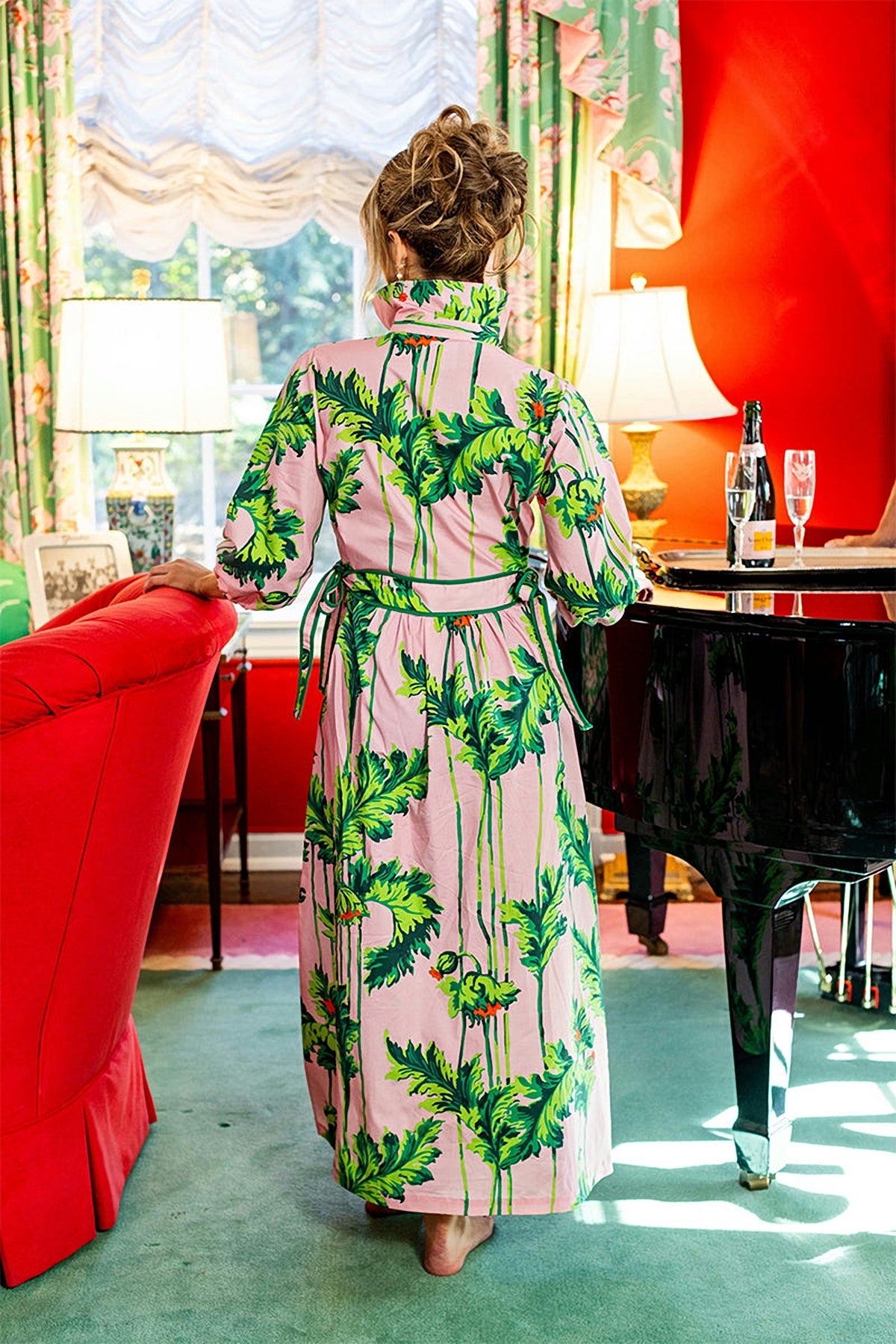 Back view of the Pink Regency long dress in a drawing room.