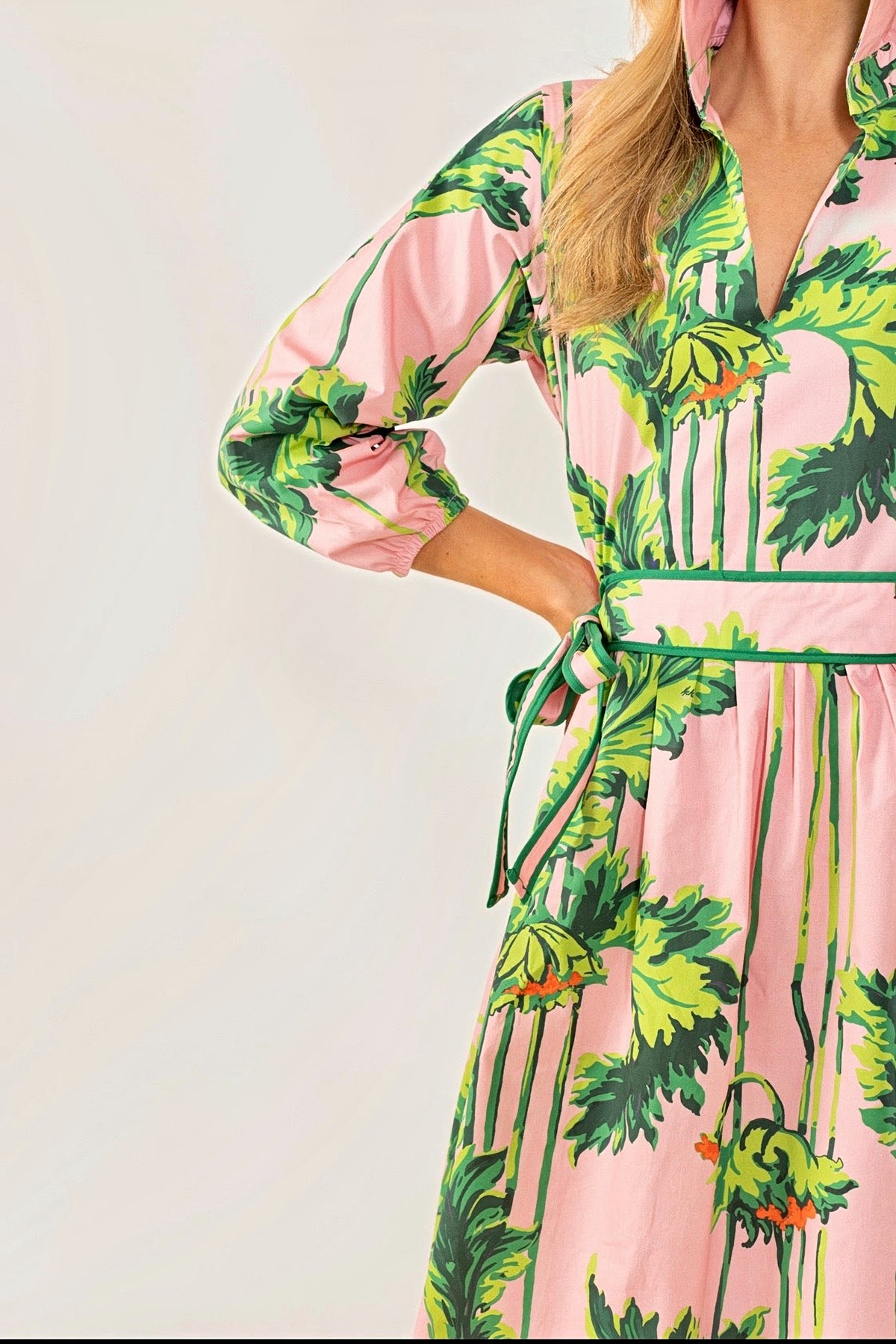 Close-up of the palm print, sleeve and tie waist on the Pink Regency long dress.