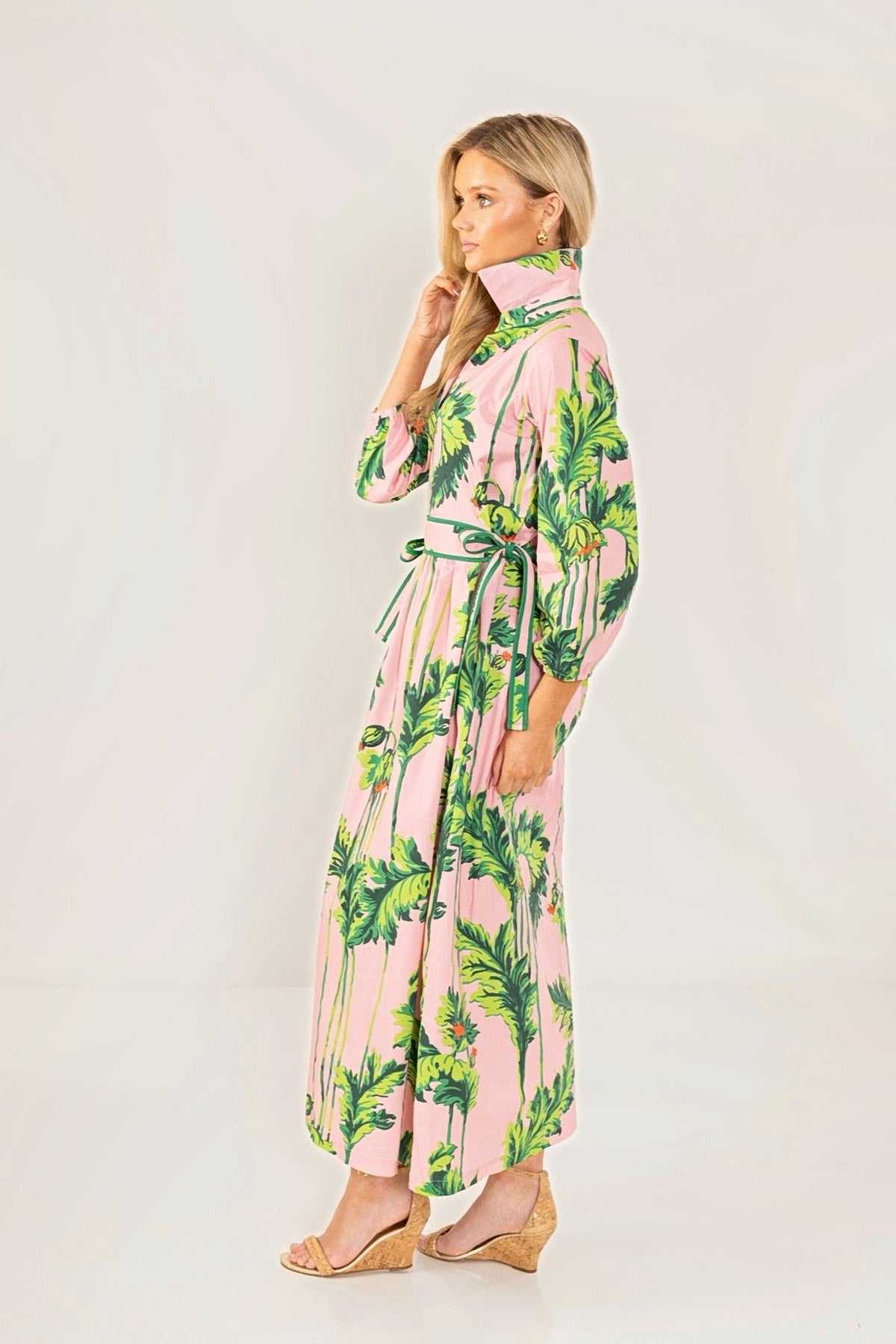 Side view of the Pink Regency long dress, showing the tie waist and full-length skirt.