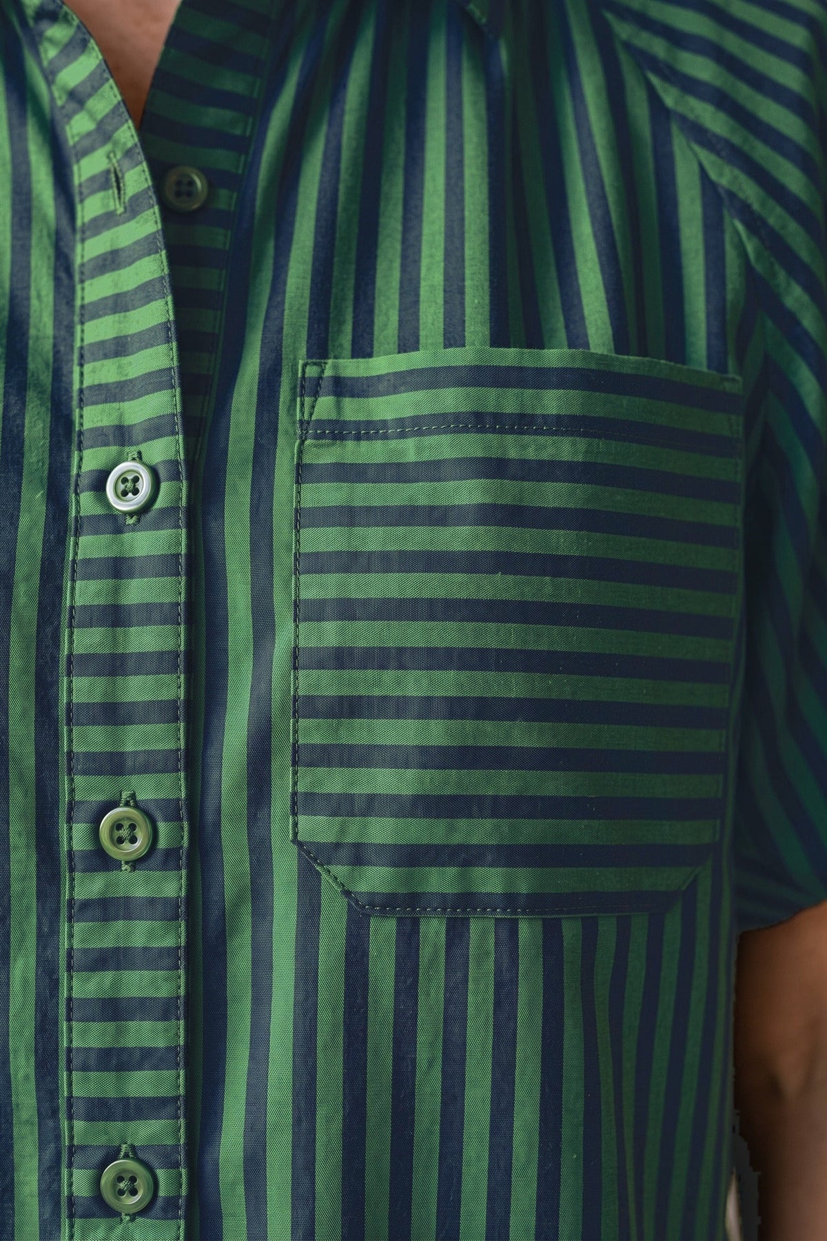 Close-up of the Preppy top's horizontal-stripe chest pocket and button placket with navy piping.