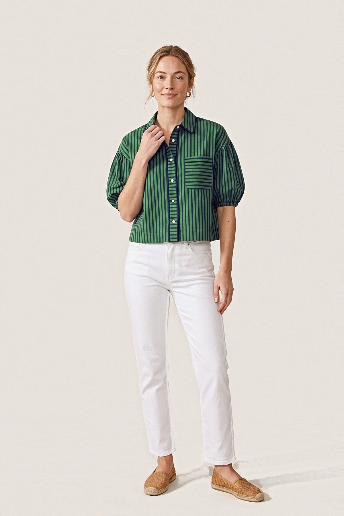 Front view of the Preppy navy and green stripe cropped shirt with balloon sleeves, piped collar and striped chest pocket, worn with white jeans.
