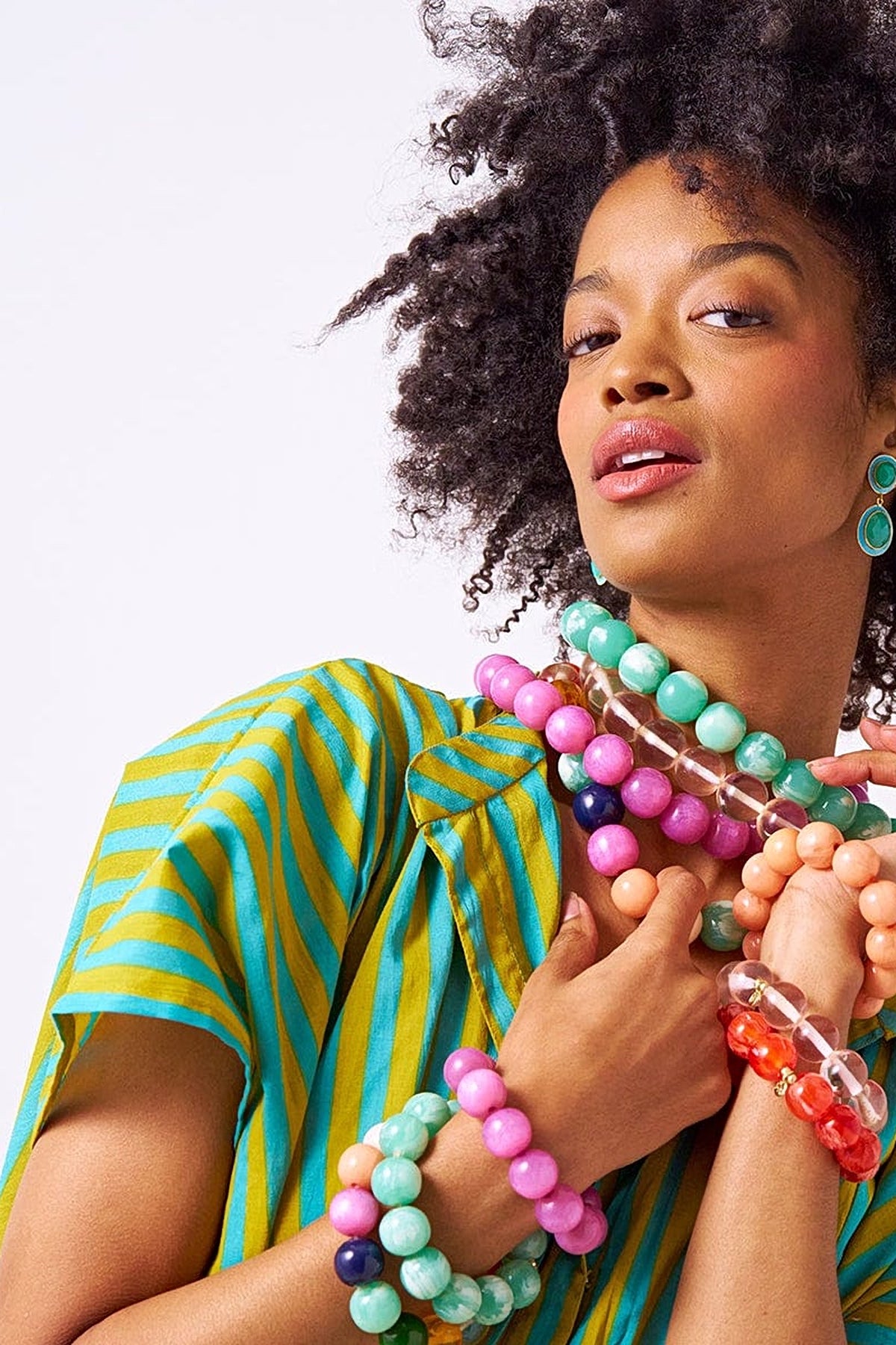 Model wearing the Purple Iris resin bead necklace with stacks of colourful Cece bead bracelets.