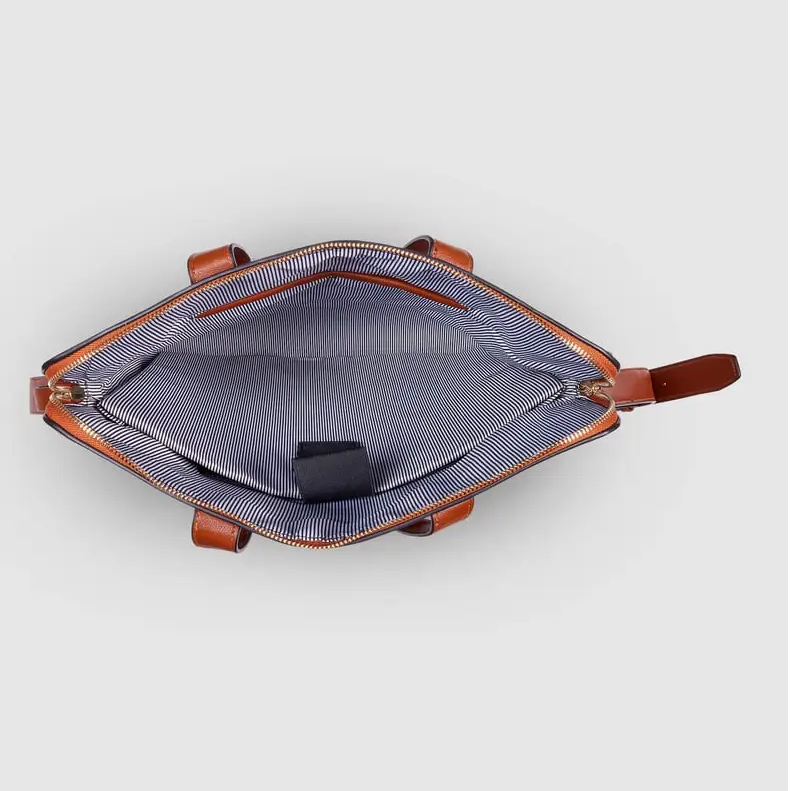 Open bag with brown leather straps on a white background