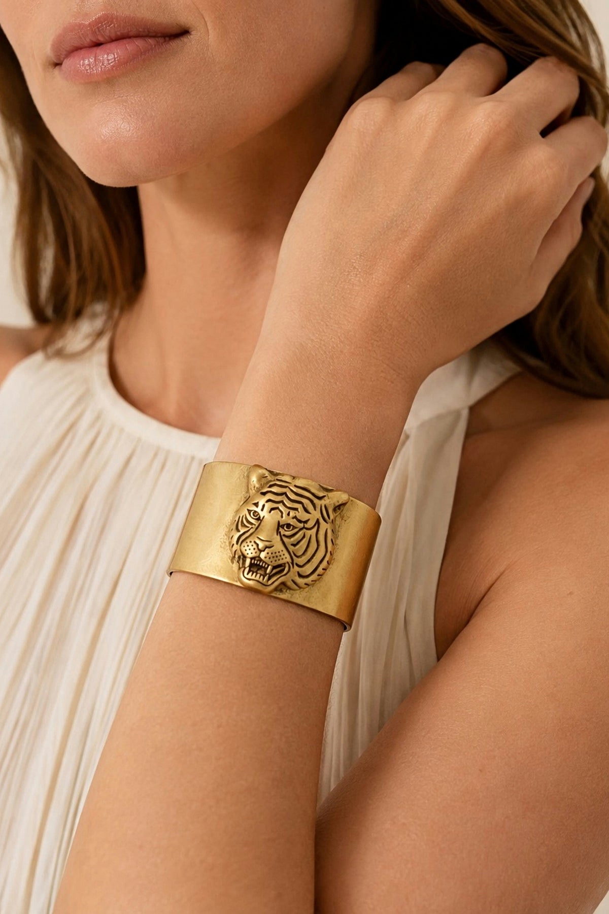 Tarina Tiger Head Cuff worn on the wrist, showing the width of the gold cuff.