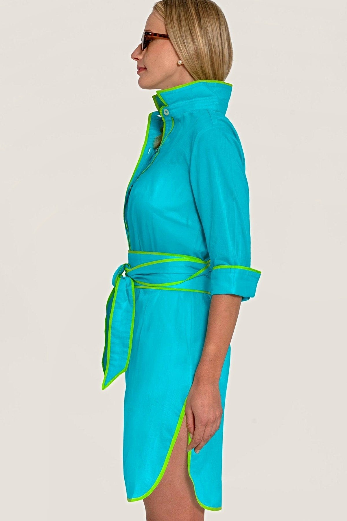 Side view of the turquoise shirt tails dress, showing the curved hem and tie belt.