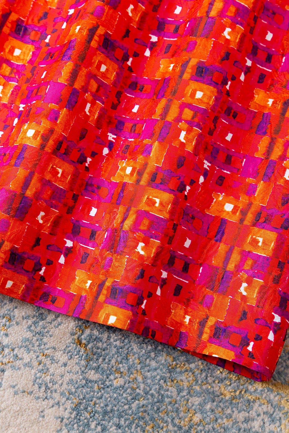 Close-up of the woven red, pink and orange jacquard of the Vintage Poppy Bloom Jacquard Midi Dress