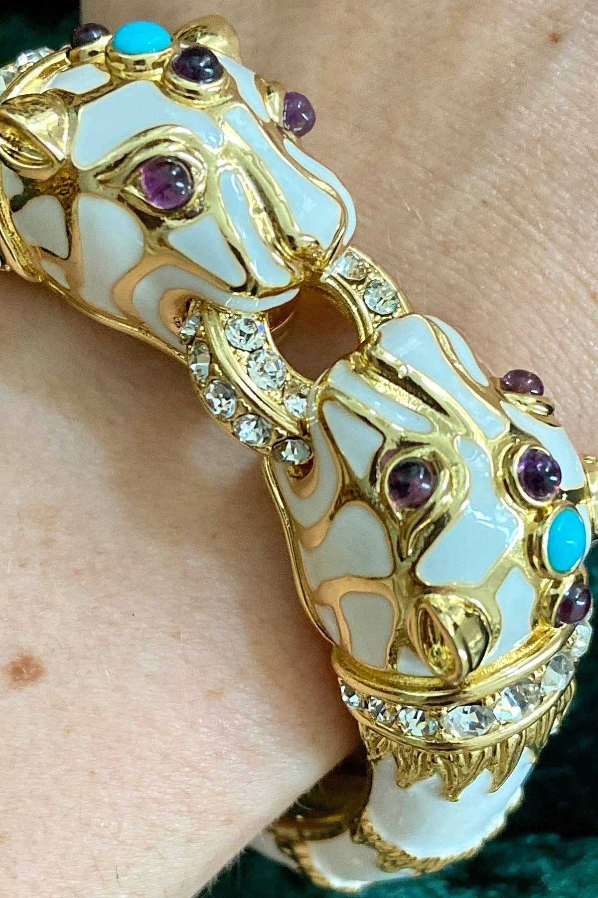 White Enamel Double Panther Bracelet worn on the wrist, showing the two panther heads with amethyst and turquoise cabochons.
