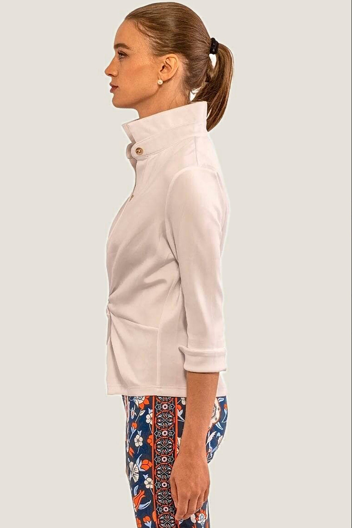 Woman wearing a white jersey shirt with rolled-up sleeves on a white background
