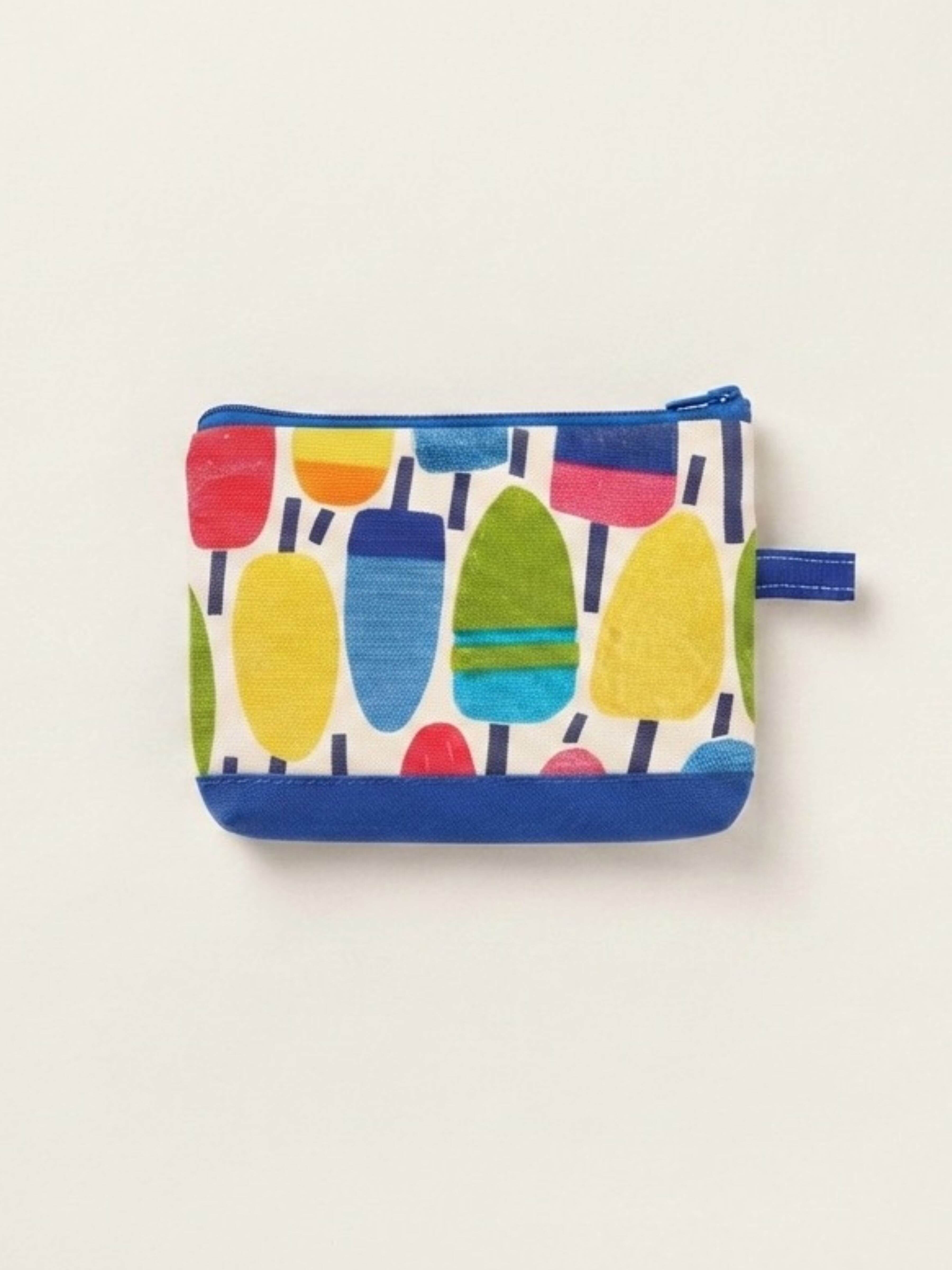 A small zippered pouch with a colorful popsicle print on a white background, featuring blue trim and a blue zipper pull, shown against a plain off-white background.