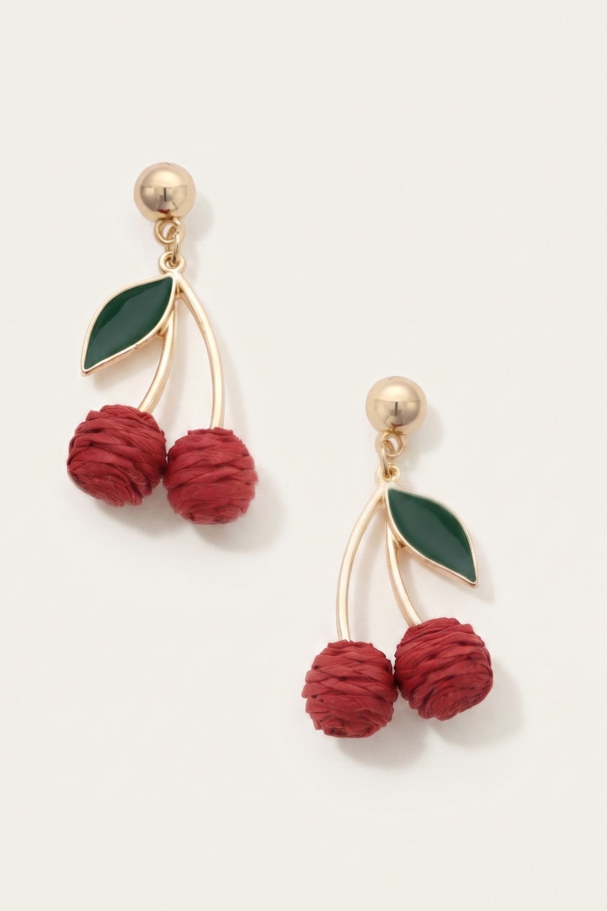 Cherry Red Raffia Drop Earrings on a cream background