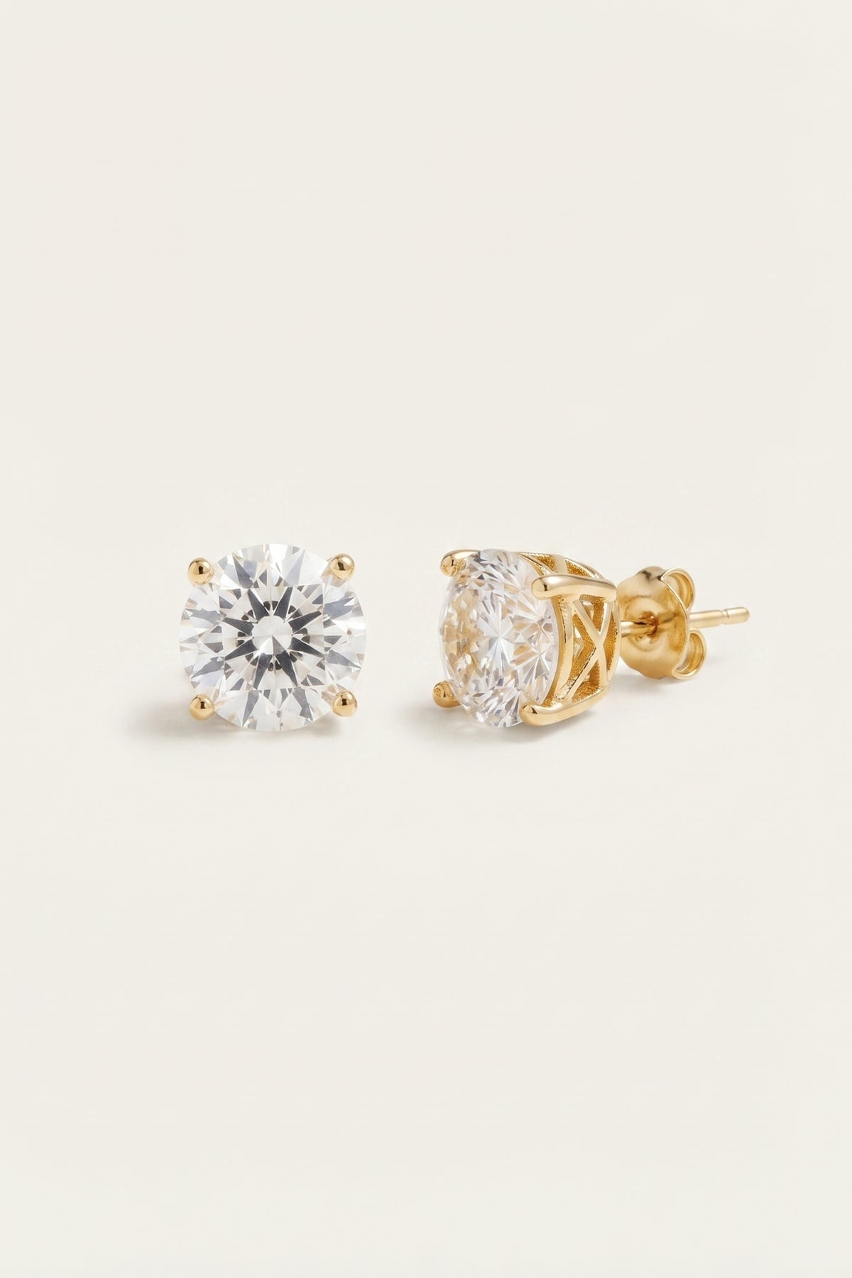Classic Clear Sparkle Studs | Gold Tone Setting on a cream background