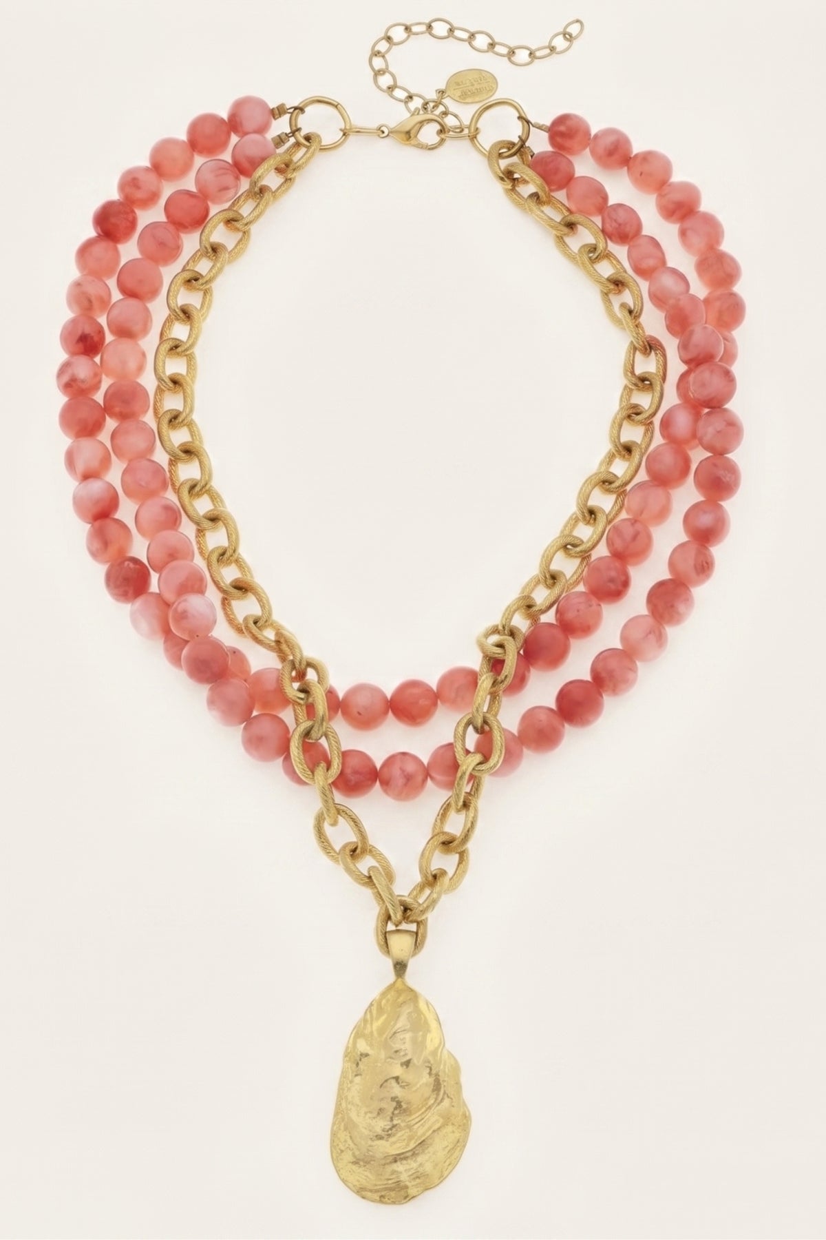 Gold Oyster and Coral Necklace on a cream background