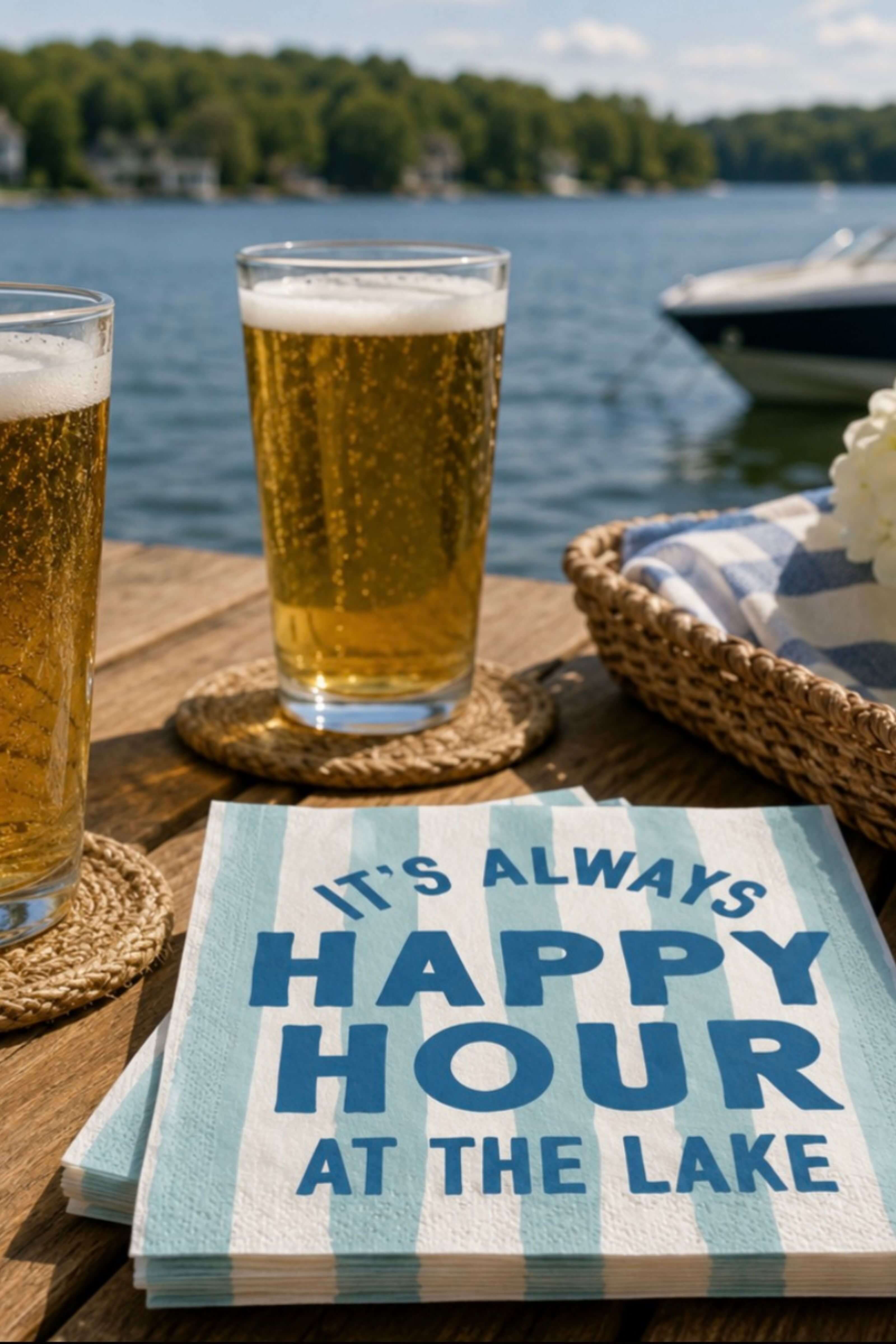 It's always happy hour at the lake cocktal napkins are displayed on a table with a few beers. 