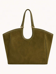 An olive green suede tote bag with double top handles and gold-tone hardware, shown against a plain off-white background.