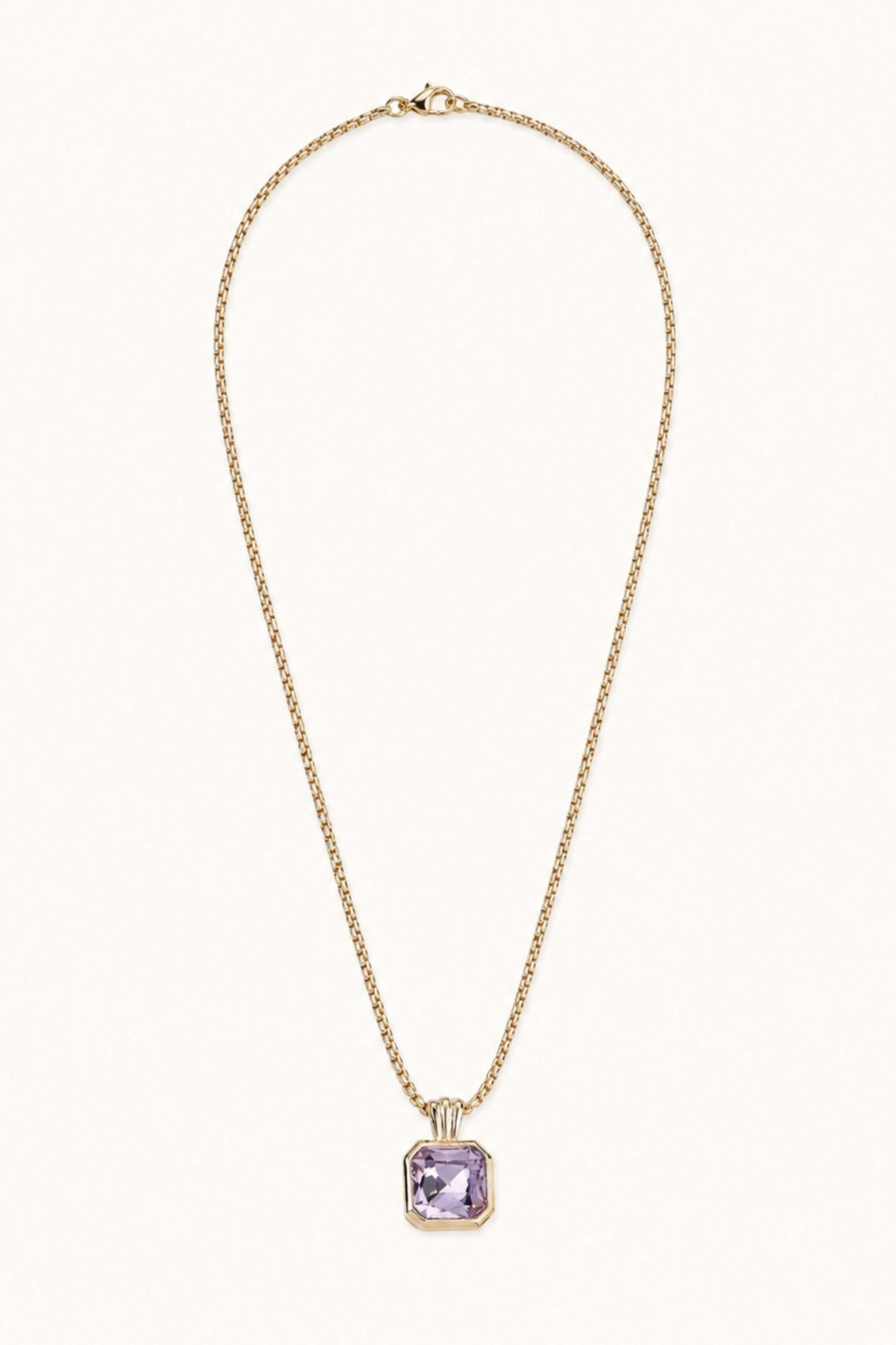 A delicate gold chain necklace with a square bezel-set light purple gemstone pendant, displayed against a solid off-white background.