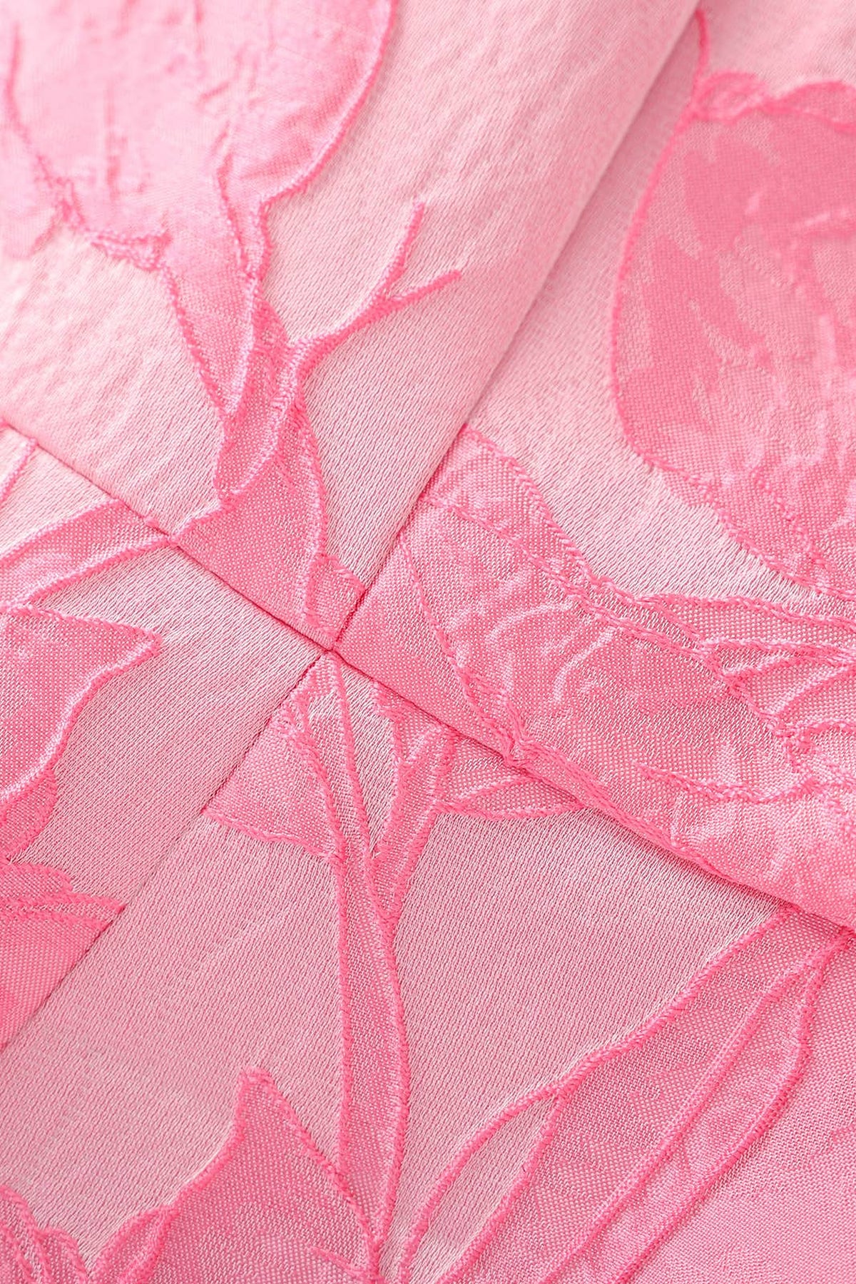 Close-up of the Pink Floral Jacquard Mini Dress fabric, showing the raised woven floral texture and the bodice seams